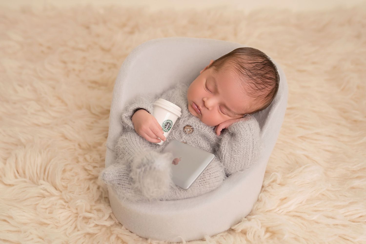 Minimalist newborn photography featuring soft gray circular cushions and neutral tones. San Diego Newborn Photographer