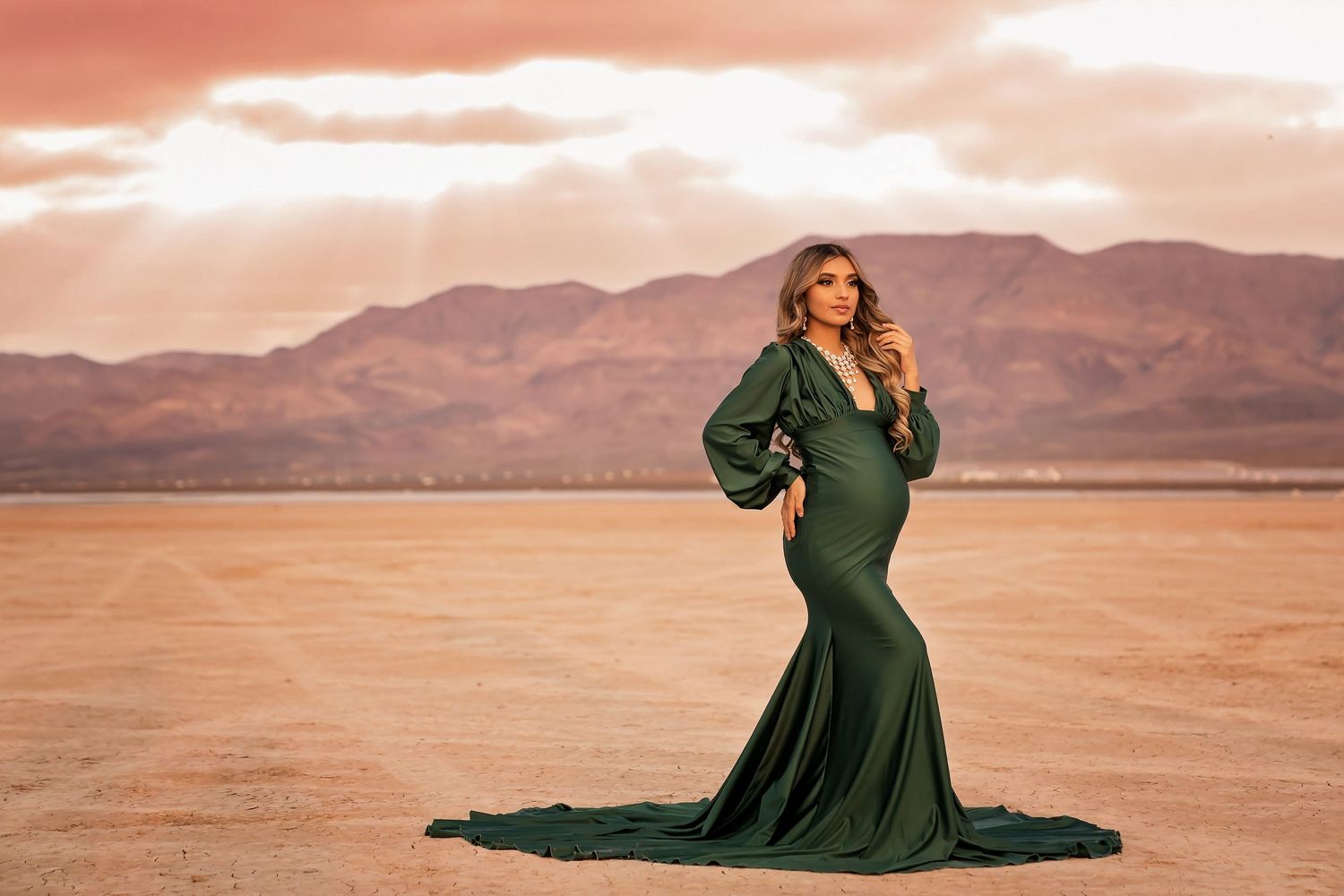 Flowing dark dress against desert mountain backdrop at sunset. San Diego Maternity Photographer