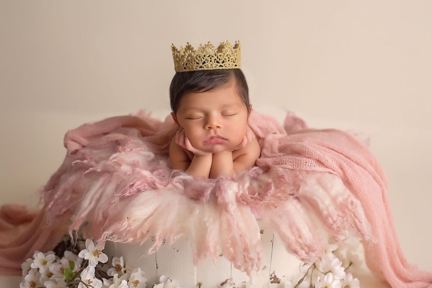 Newborn portrait series with pink tulle dress and golden crown accessories. San Diego Newborn Photographer