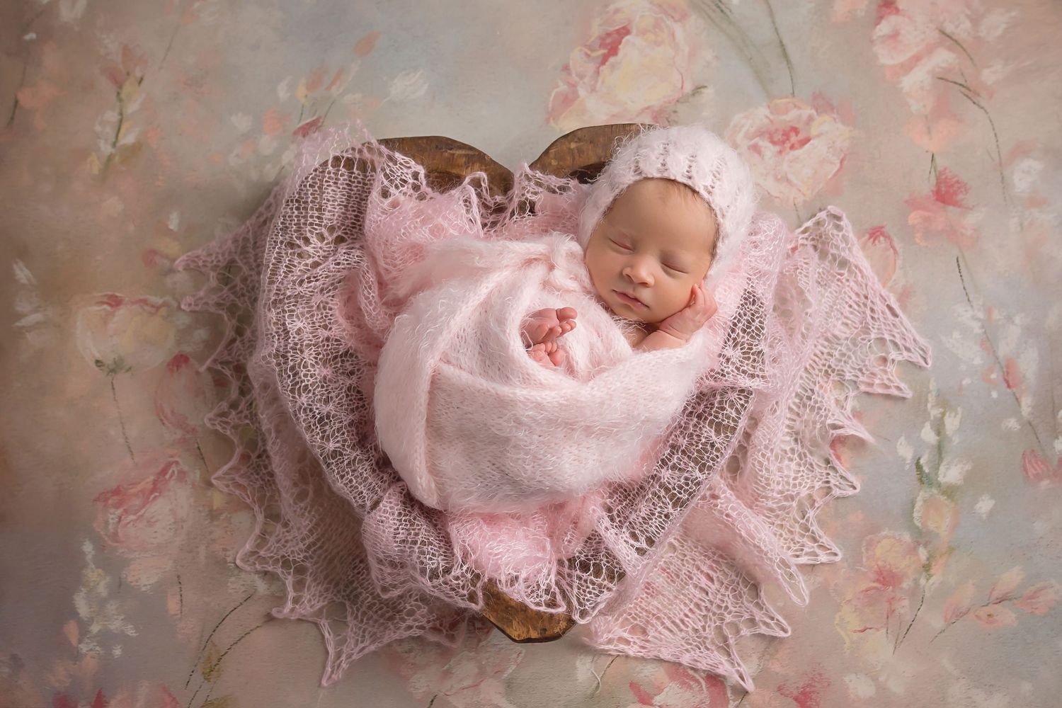 Delicate pink lace and floral backdrop creates dreamy newborn photography setting. San Diego Newborn Photographer