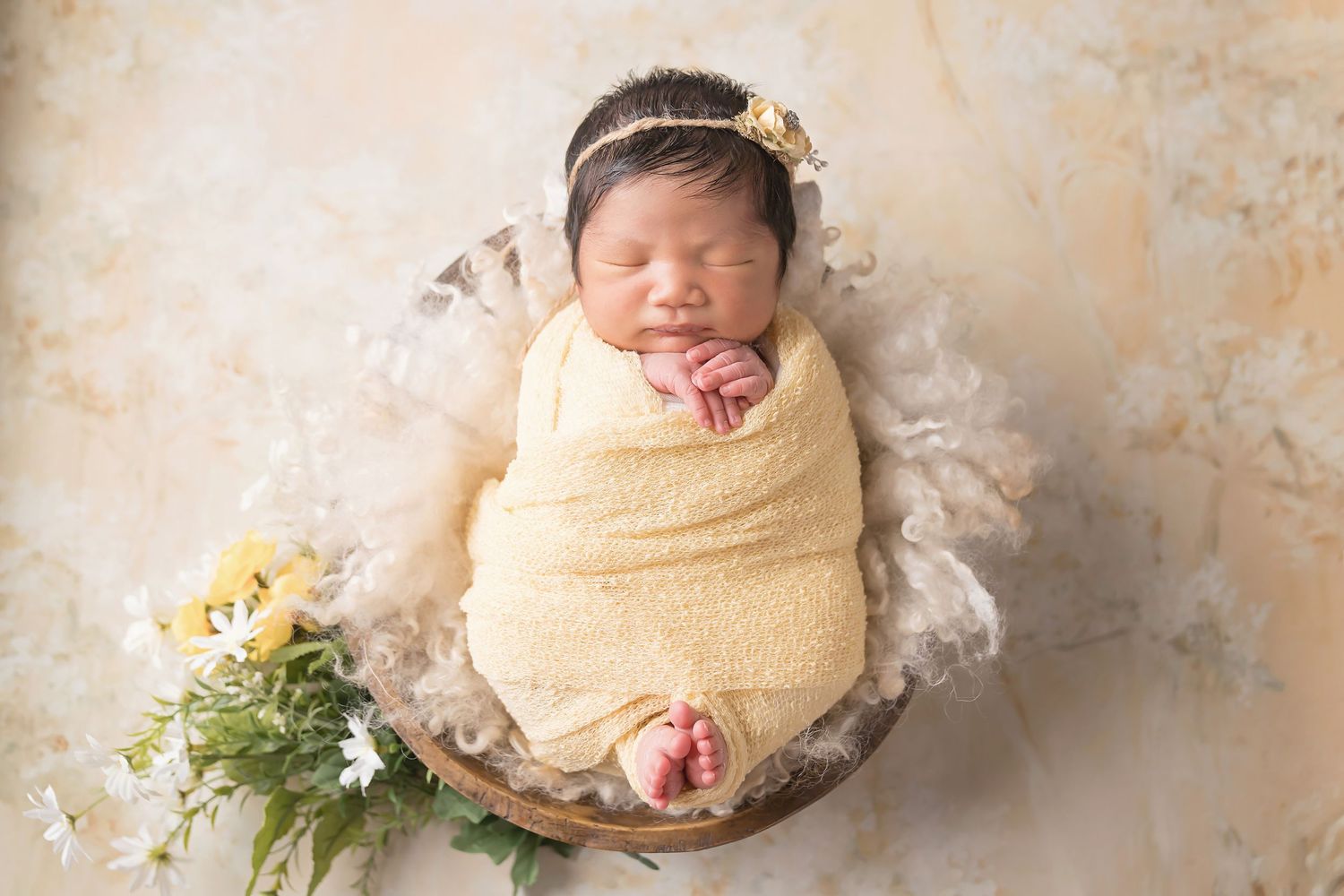 Rustic newborn photography setup with floral accents and natural textures. San Diego Newborn Photographer