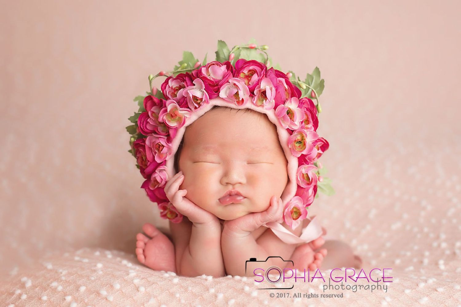 Artistic newborn portraits with pink rose crown and sparkly pink background. San Diego Newborn Photographer
