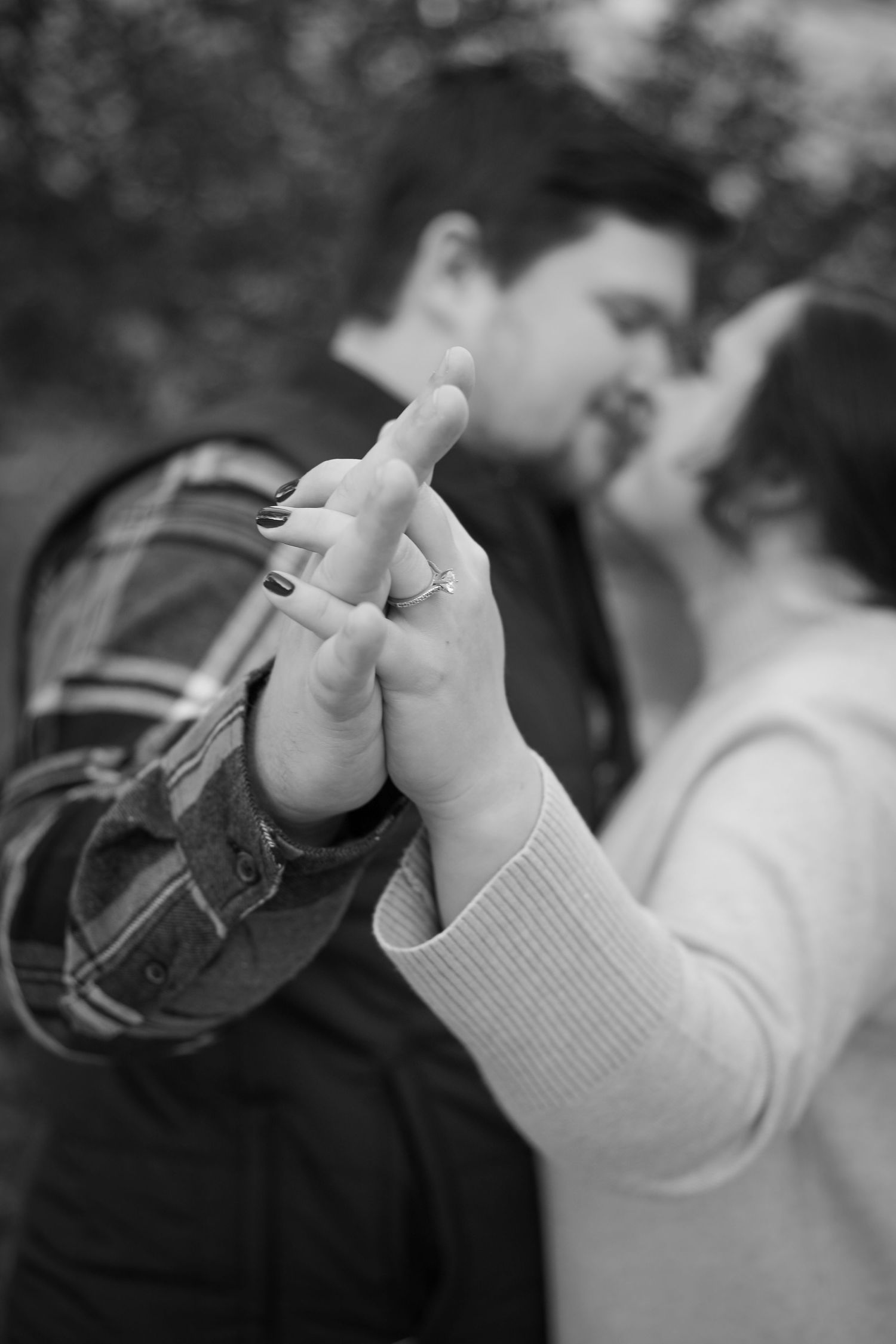 Black and white photography of a young and recently engaged couple.