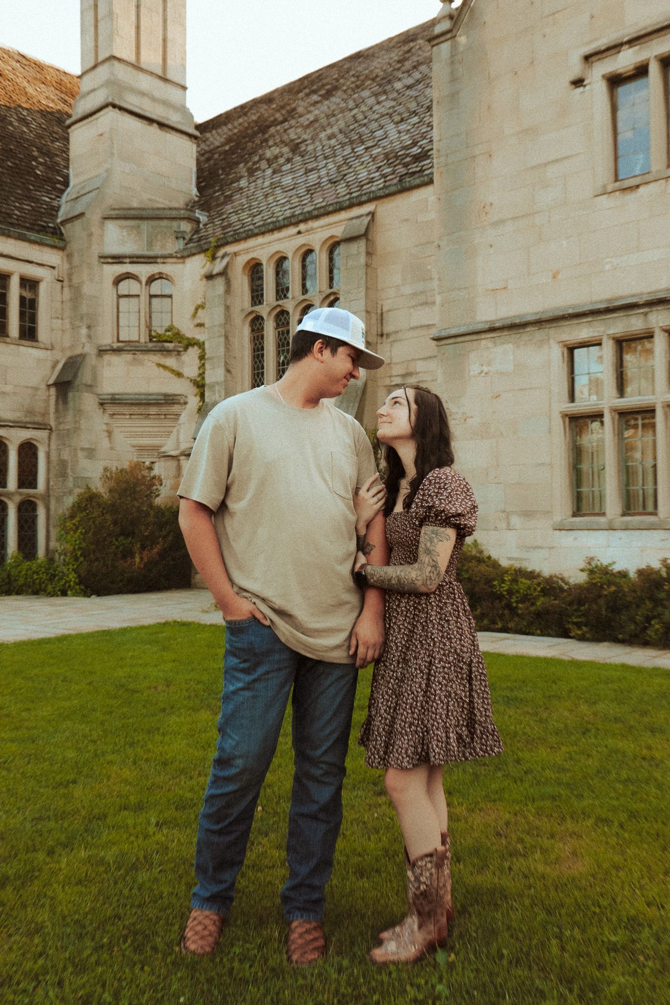 Couple on the lawn of a mansion.