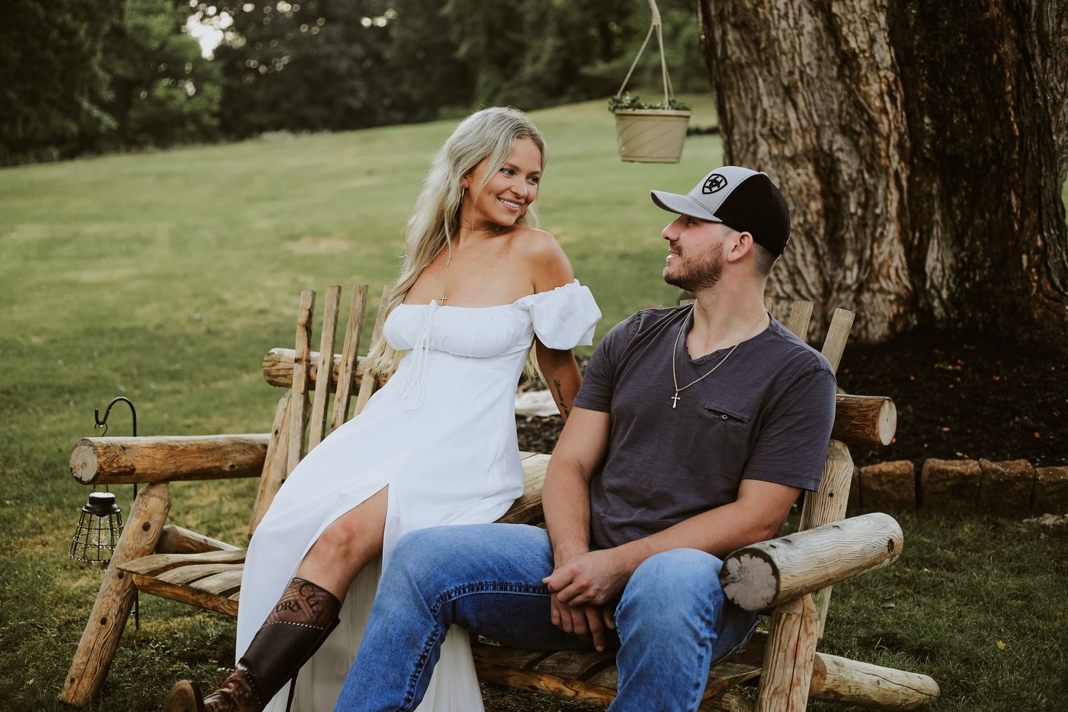 Recently engaged couple sitting on a bench.