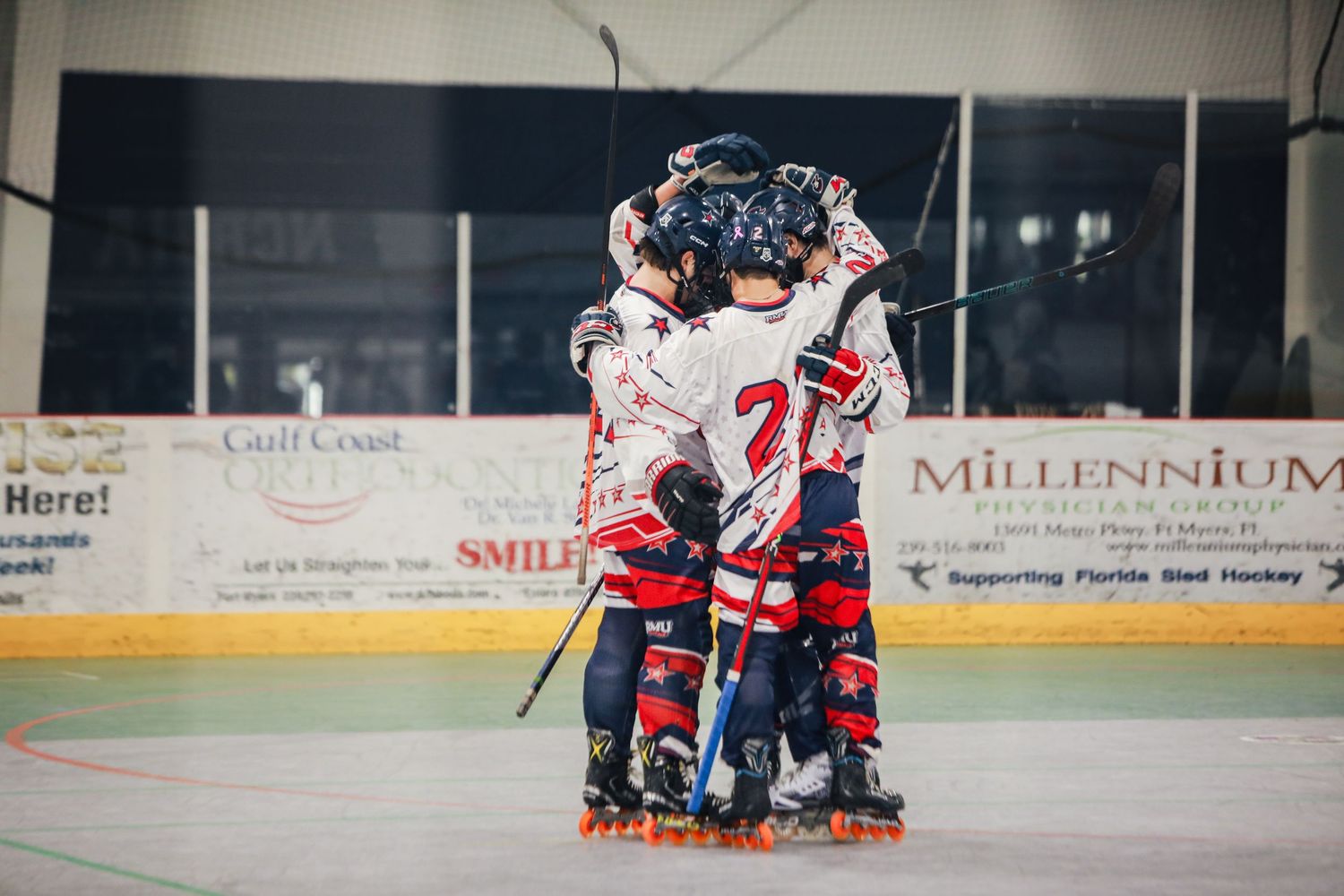 Multiple Robert Morris hockey players celebrating after a game win/