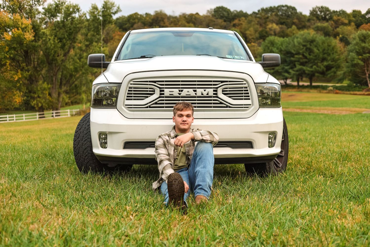 young man portrait taken with his white truck