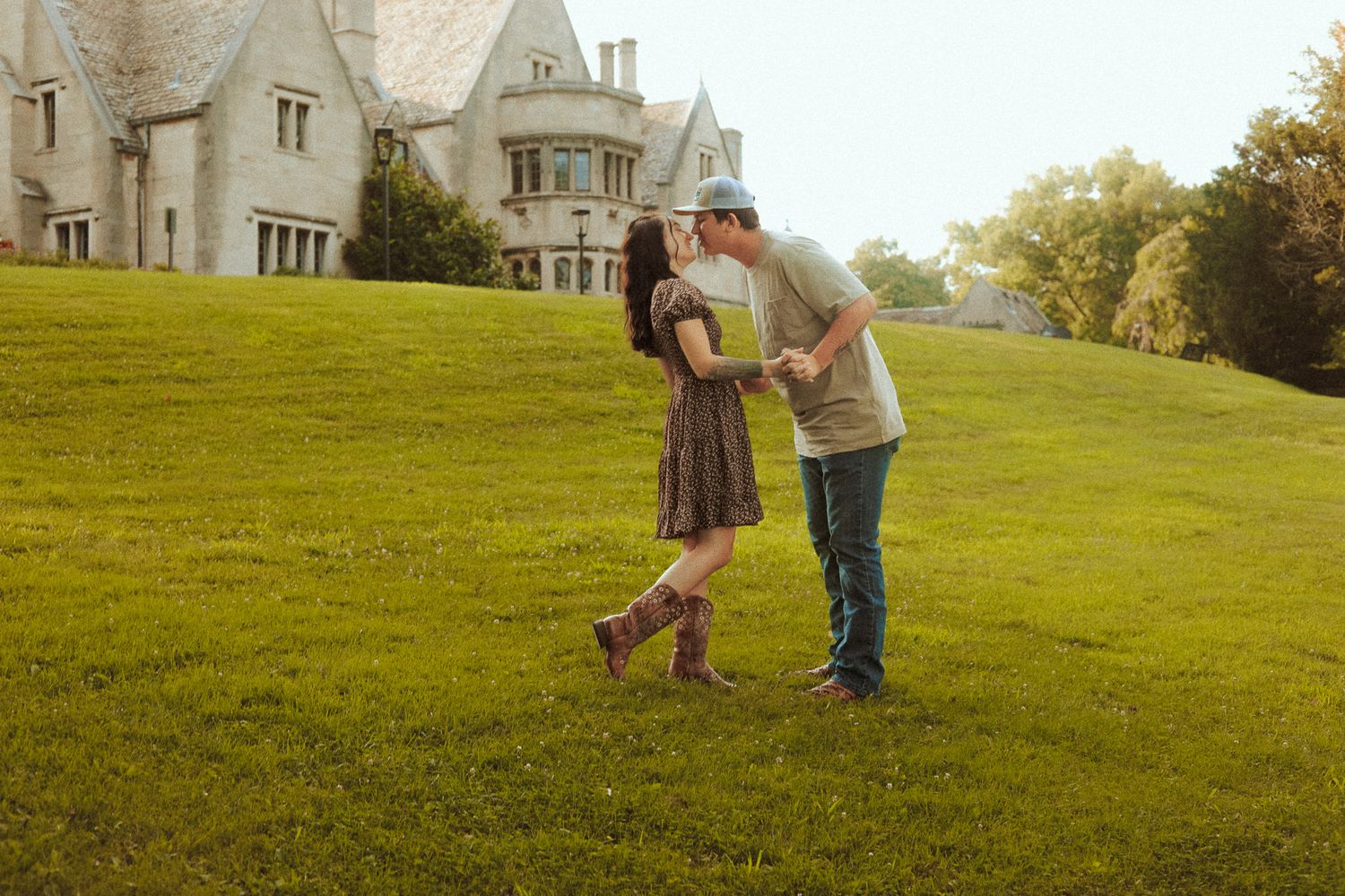 happy couple dancing in a field photoshoot