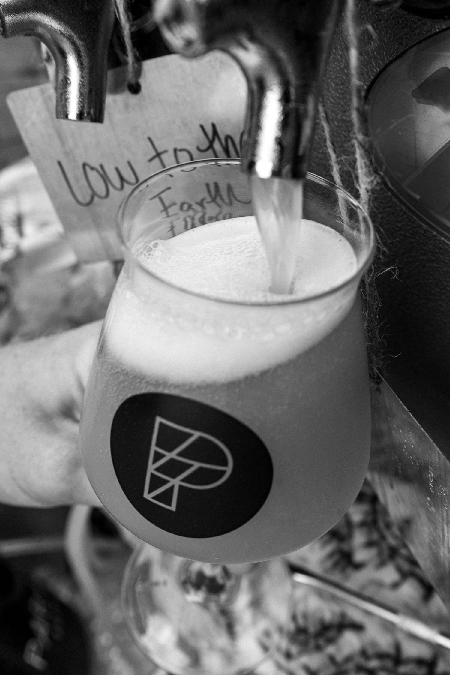 Close-up shots of craft beer being poured into glasses showing frothy foam heads.