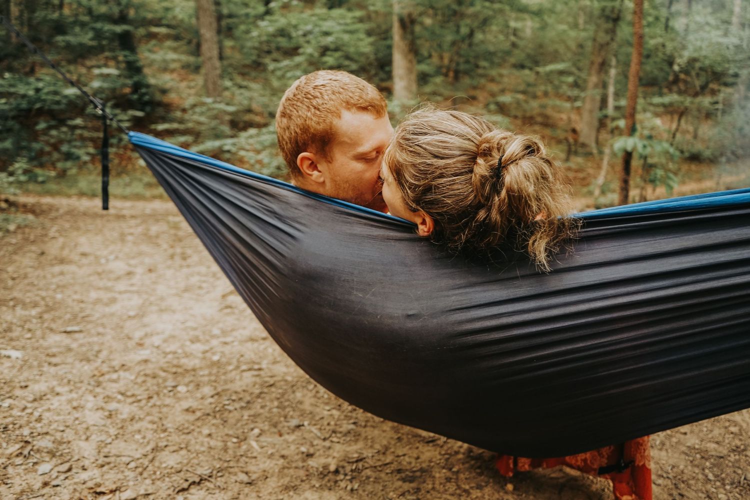 Six sequential photos show someone relaxing in a black hammock strung between trees in a wooded outdoor setting.