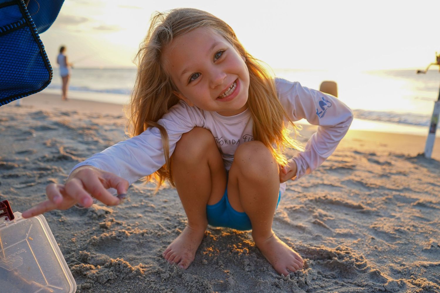Playful beach scene with golden sunlight during sunset.