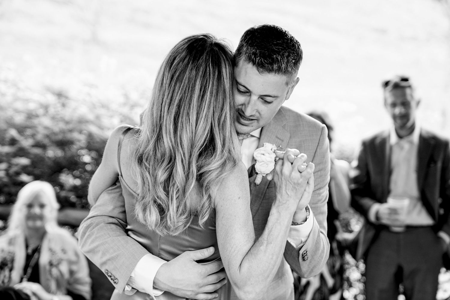 Black and white photo montage showing intimate moments between couples during an outdoor wedding celebration.