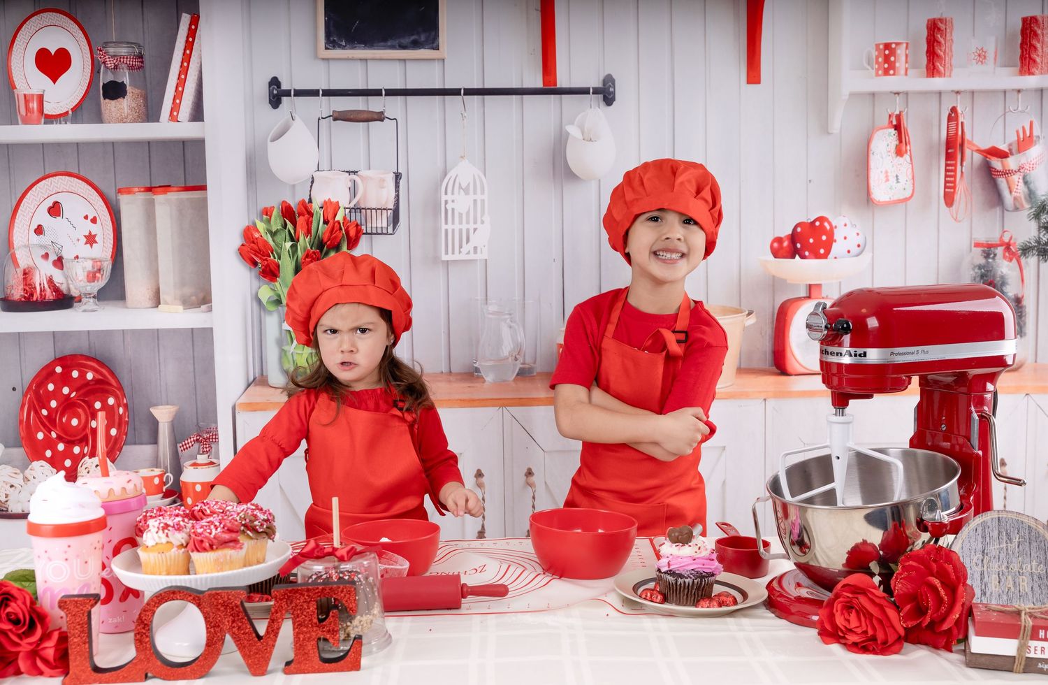 Festive Valentine's Day kitchen scene with red decor, roses, and 'LOVE' sign on display.
