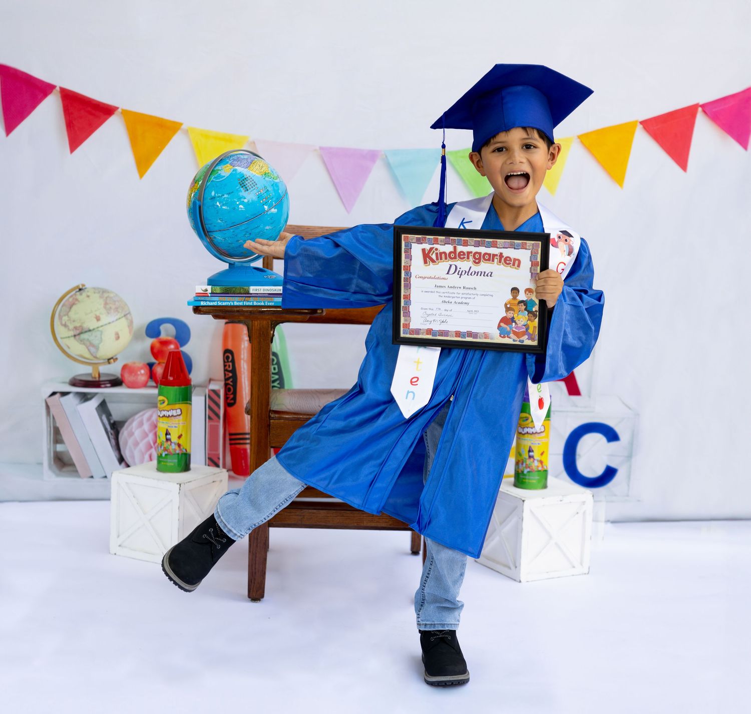 Preschool graduation celebration scene with decorative bunting and educational toys.