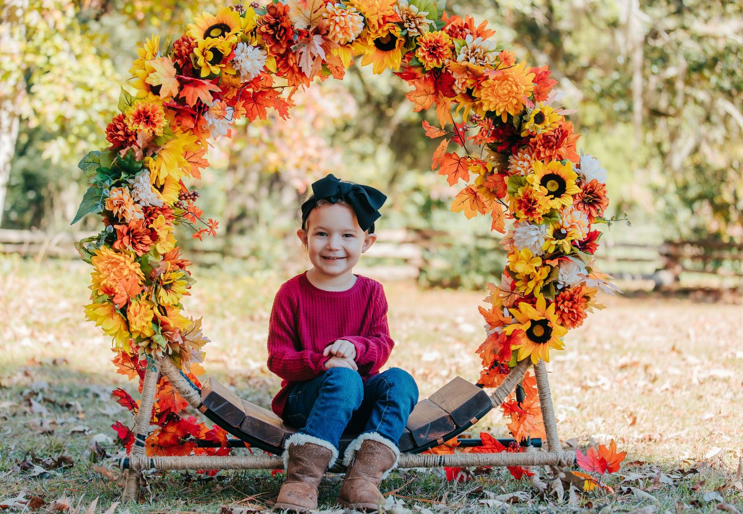 Colorful autumn wreath made of orange and red flowers creates a festive seasonal display outdoors.