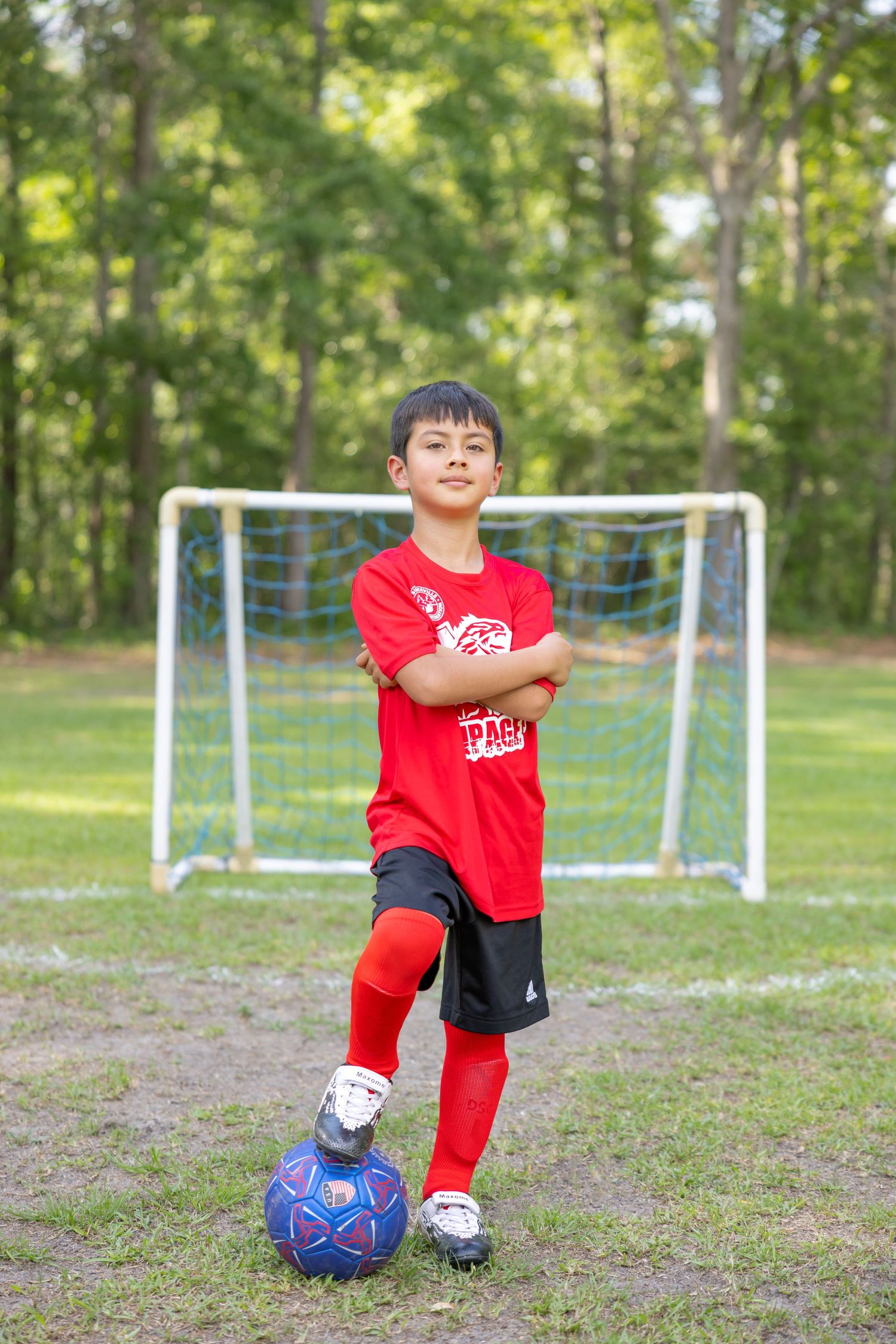 Youth soccer practice with goal posts visible on grassy field.