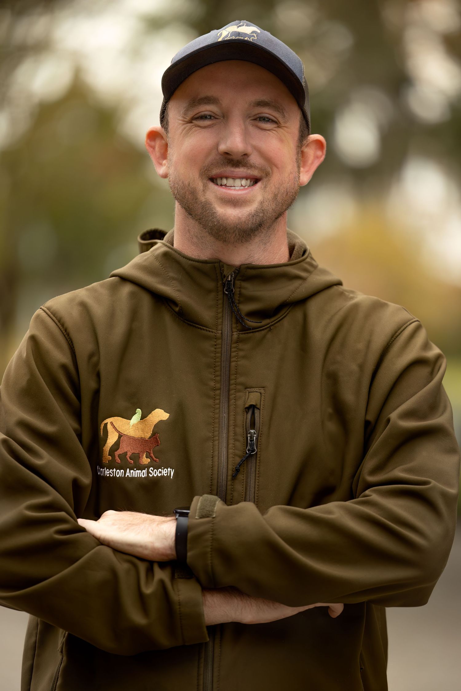 Person wearing brown hoodie with small embroidered logo shown in multiple poses against neutral background.