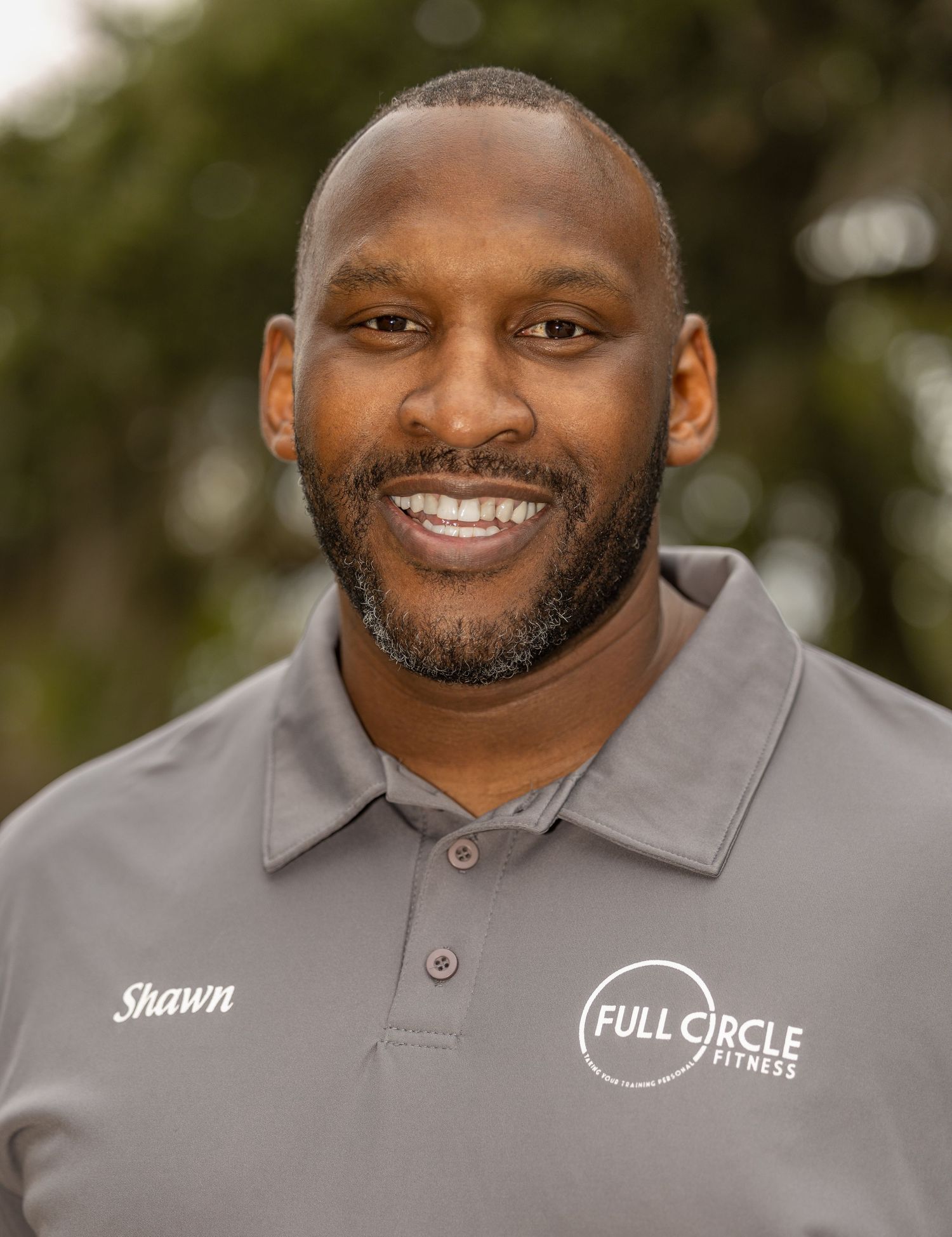 Professional headshots of person in grey polo shirt with company branding.