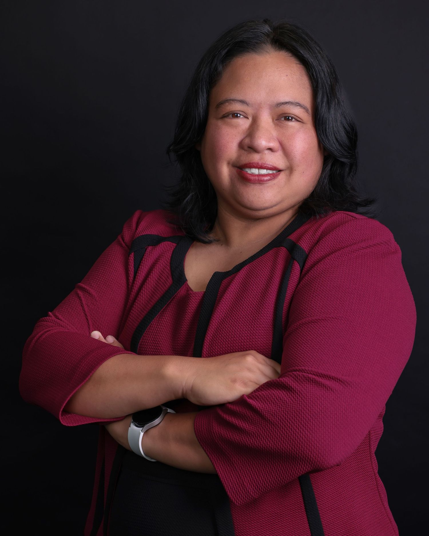 Studio headshot series showing expressive poses in magenta business attire.