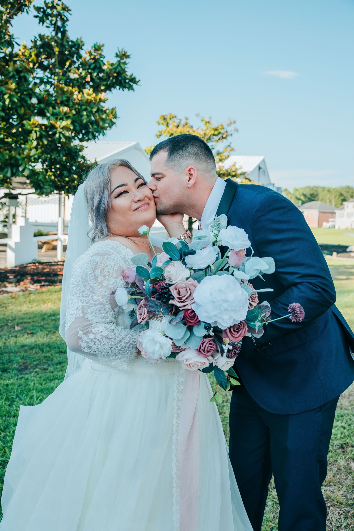 Romantic outdoor wedding portraits with floral bouquet details.