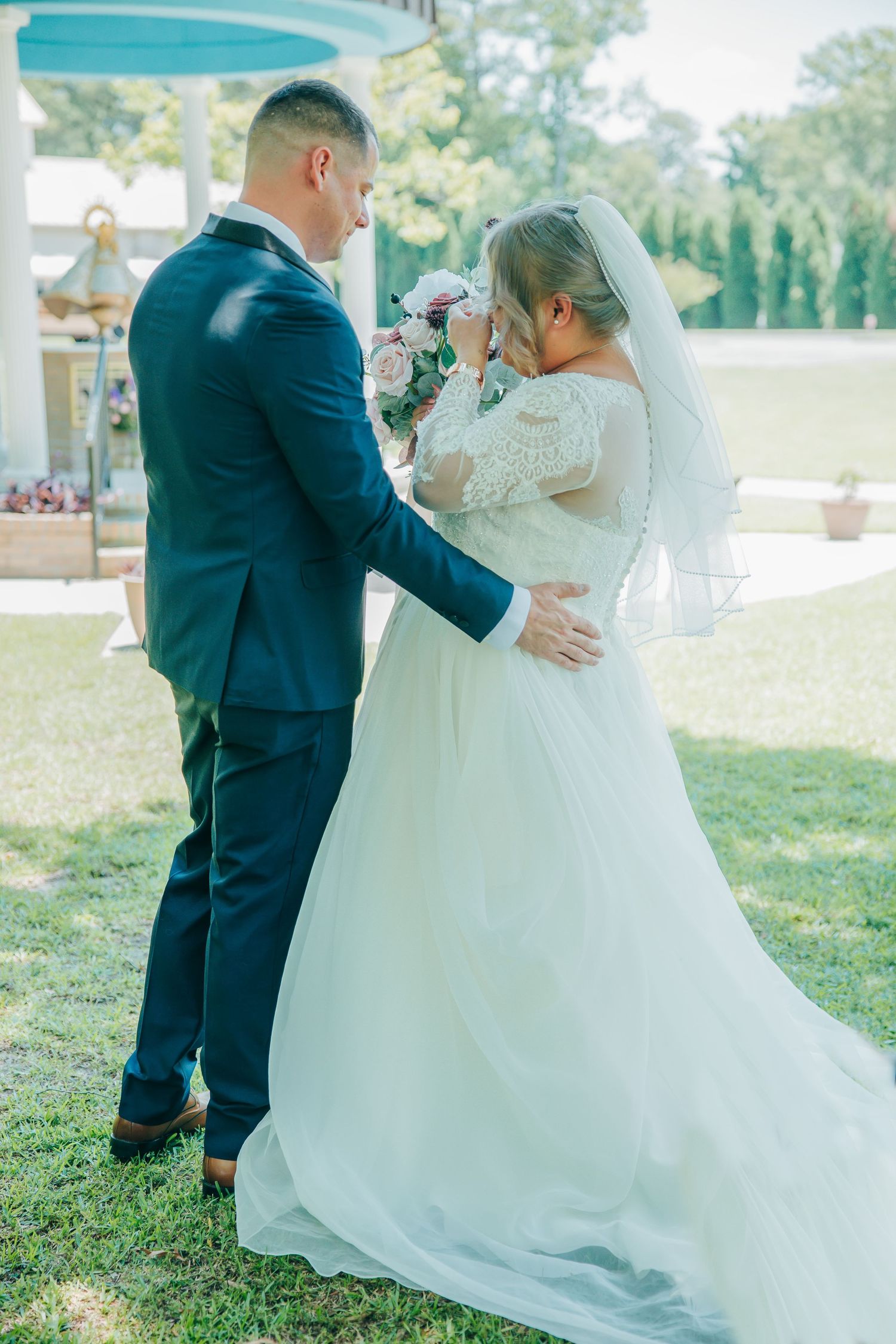 Romantic outdoor wedding portraits captured in a sunlit garden setting.