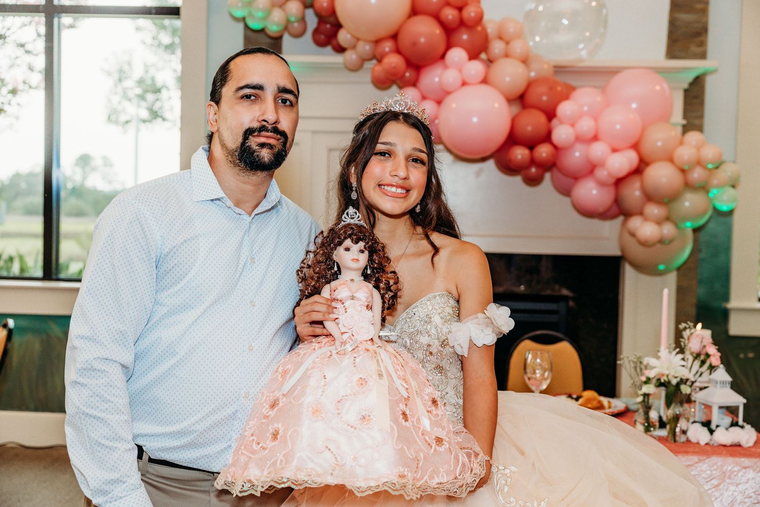 Wedding celebration with pink balloon decorations in a modern indoor venue.