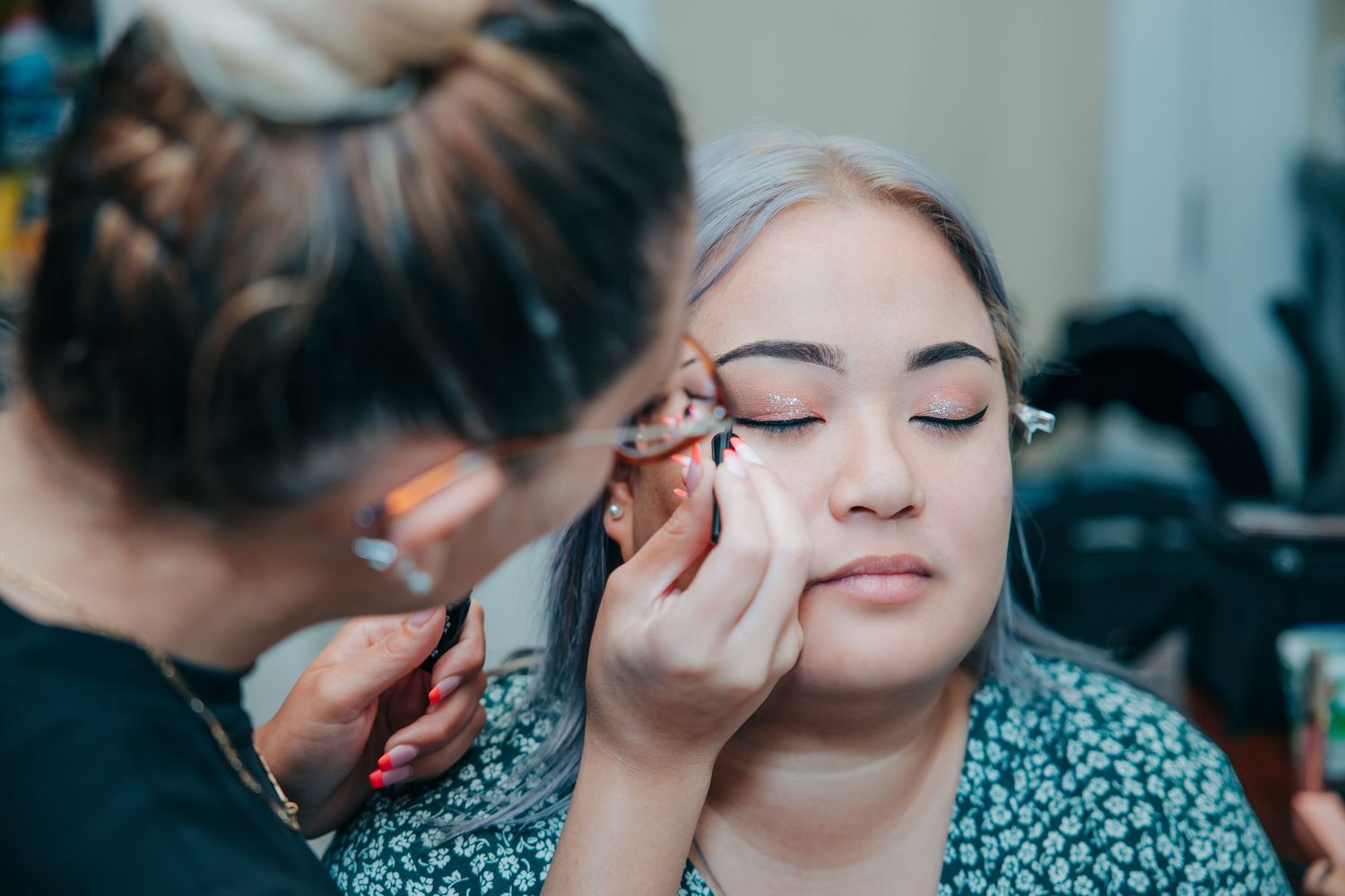 Getting ready moments before the wedding ceremony with makeup application in progress.