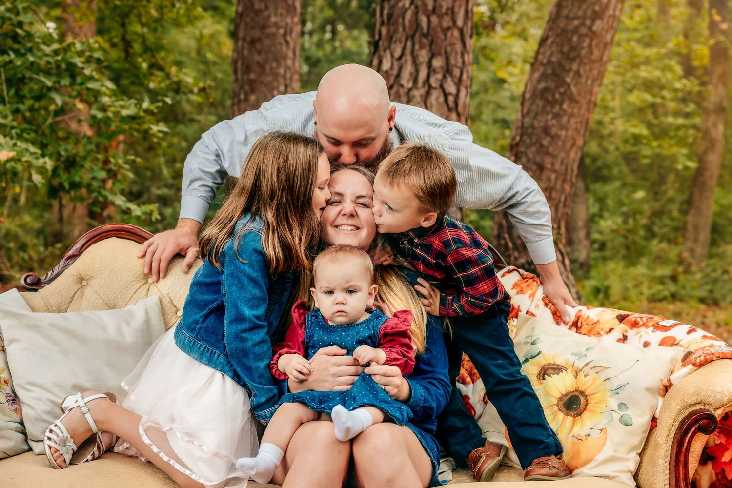 Autumn outdoor photo setup with pumpkins and fall foliage in a wooded setting.
