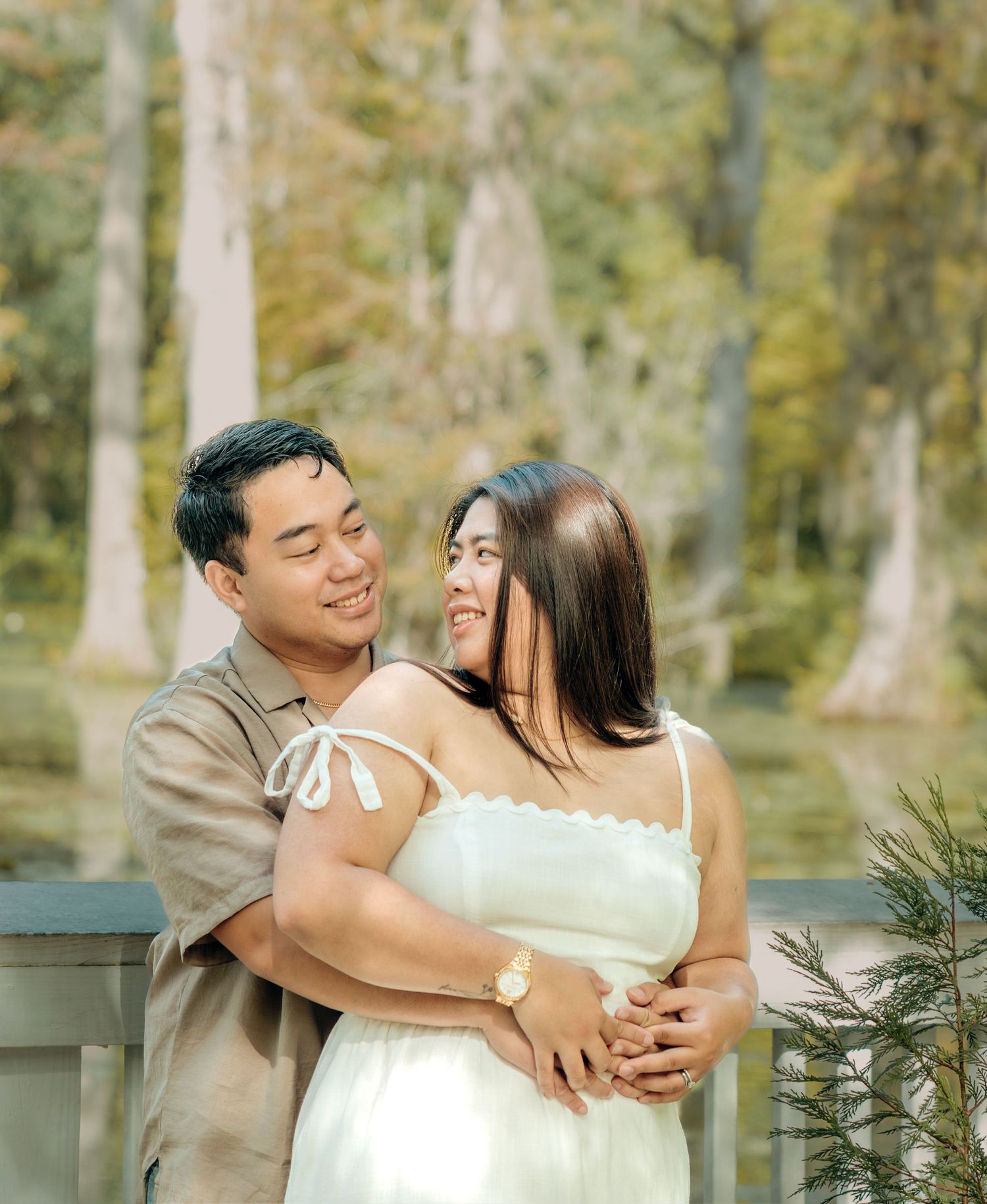 Romantic couple shares intimate moments in a dreamy outdoor forest setting.