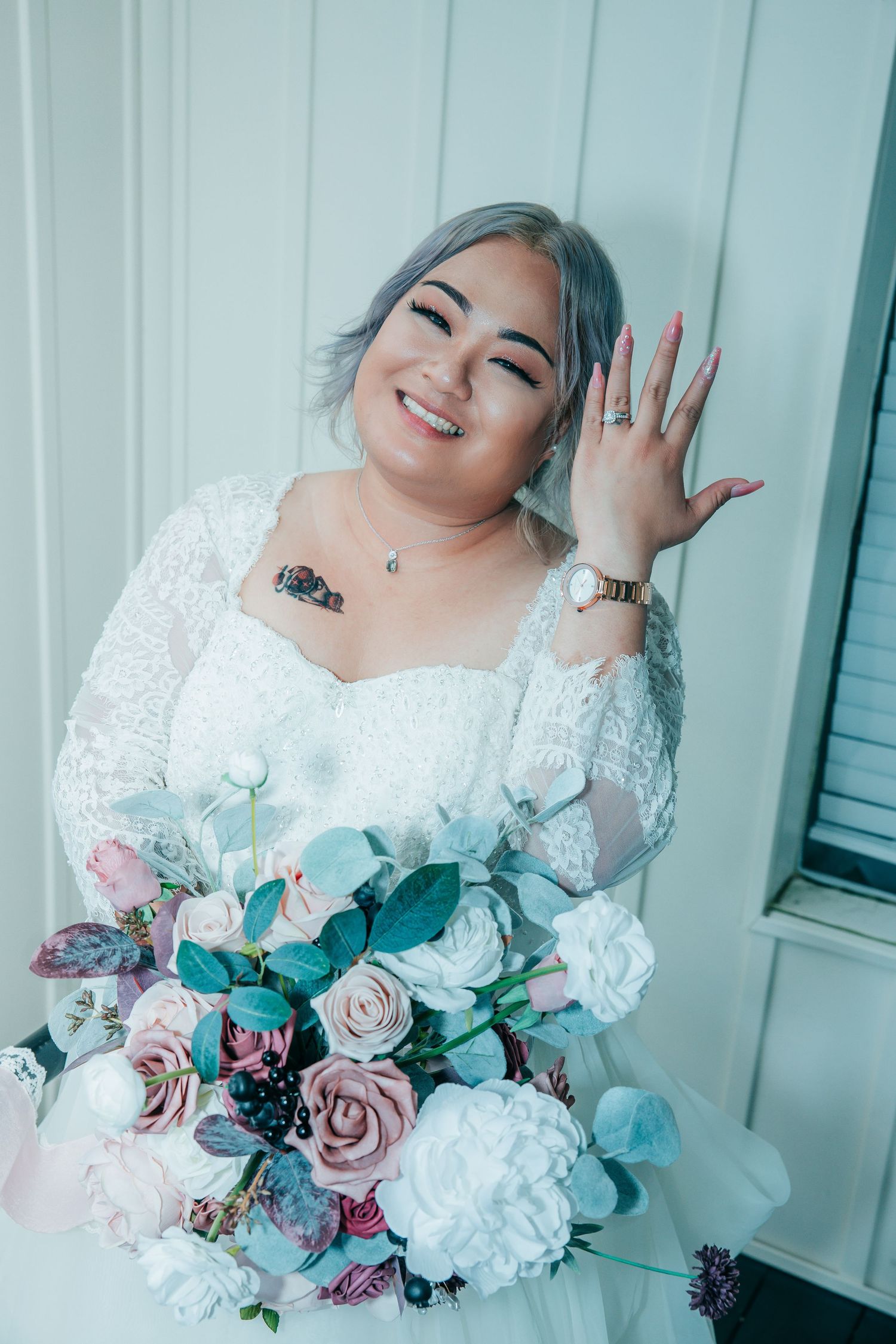 Playful bridal portraits with a stunning floral bouquet against white background.