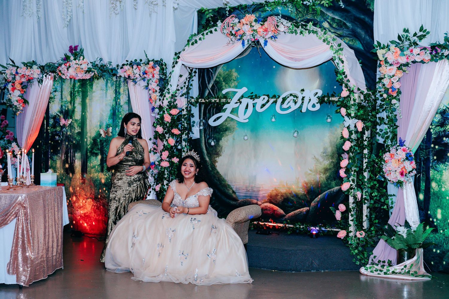 Wedding venue decorated with pink floral arrangements and ethereal white draping.