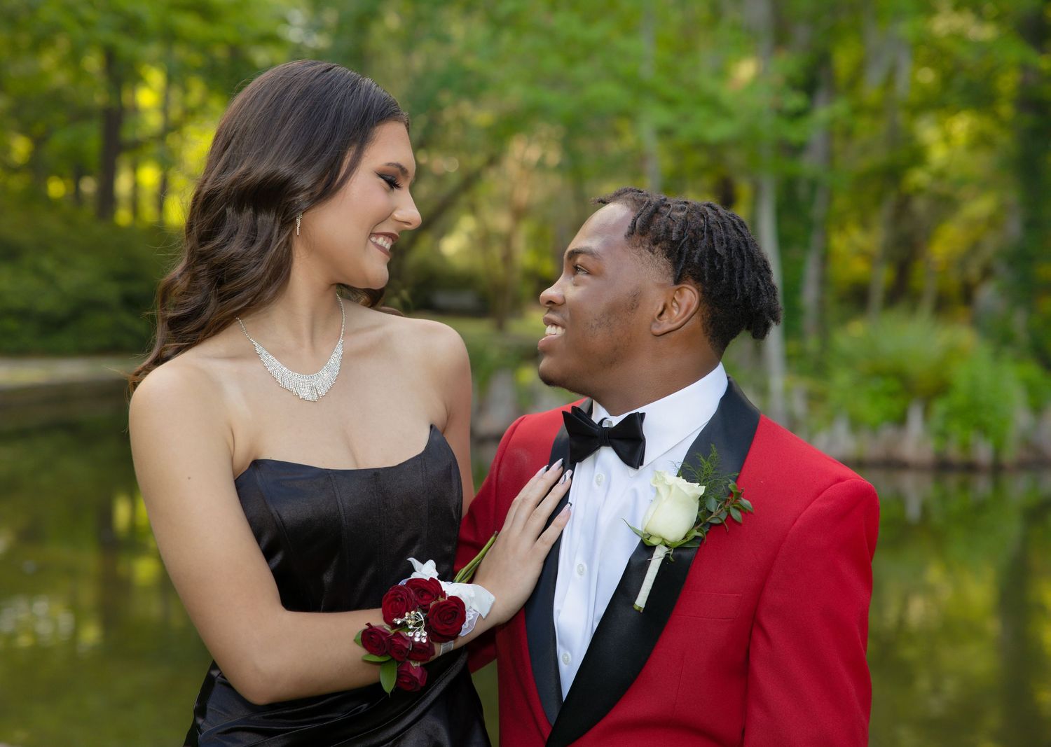 Couple in formal wear shares intimate moment during outdoor photo session.