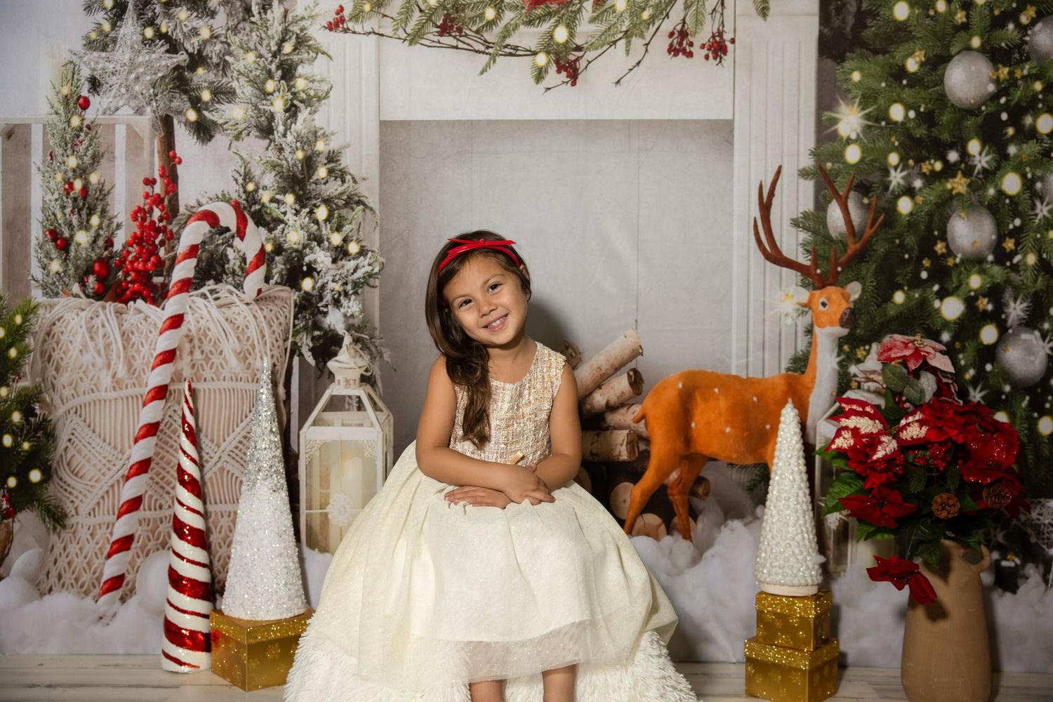 Elegant white Christmas photo setting with decorated trees, candy canes, and festive ornaments.