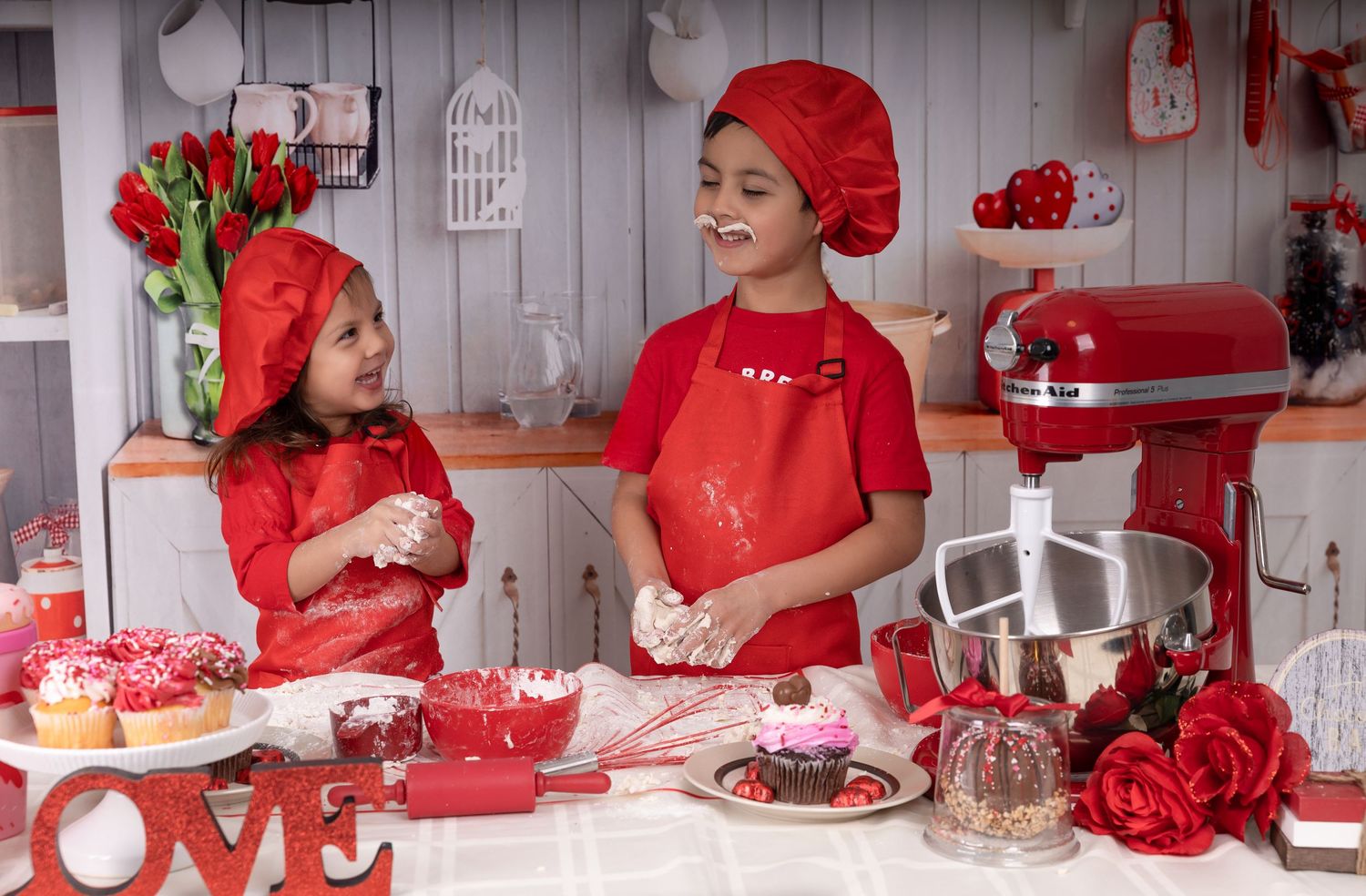 Red and white Valentine's Day themed kitchen display with heart decorations and sweet treats.