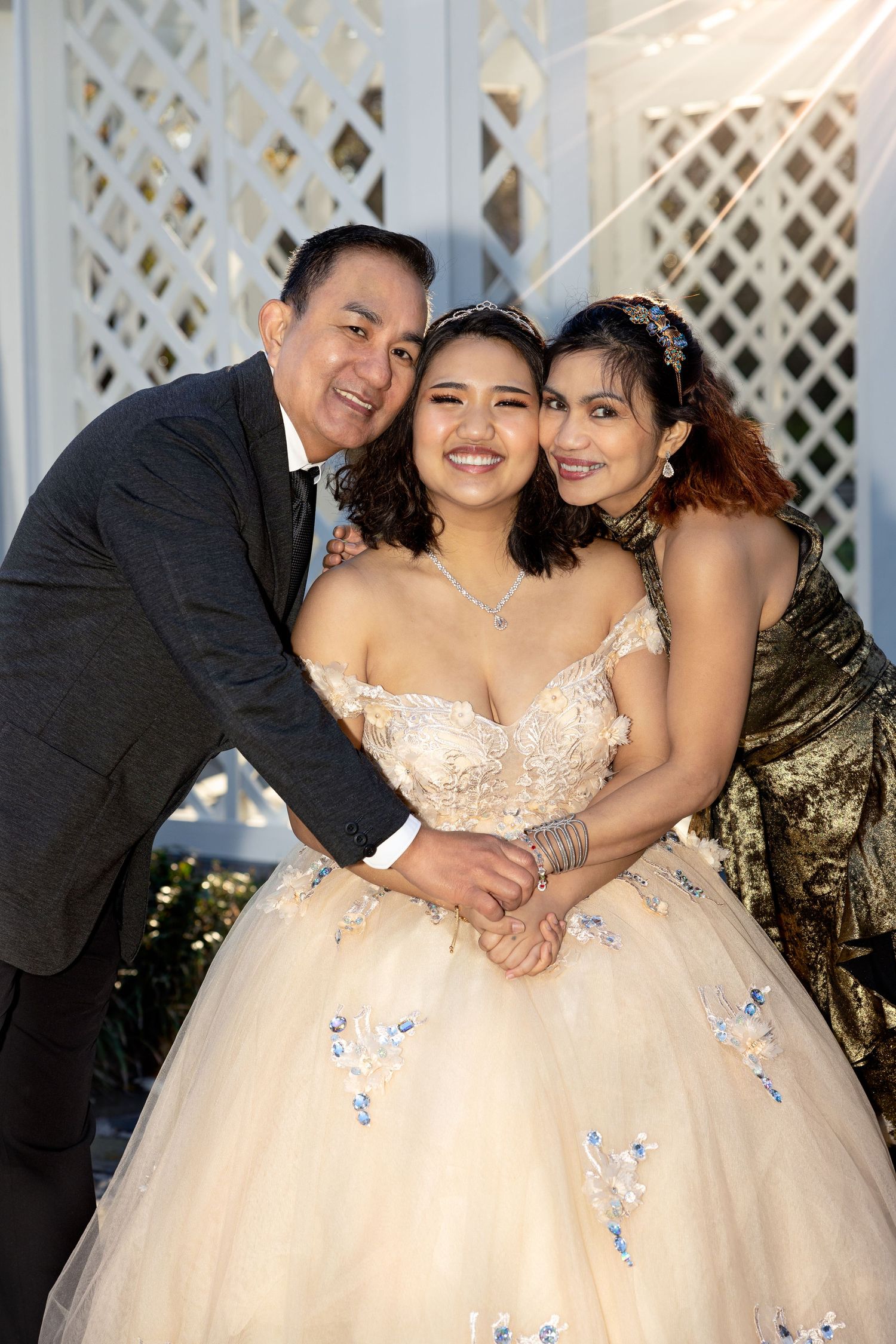 Family portrait session in front of white lattice backdrop with formal attire.