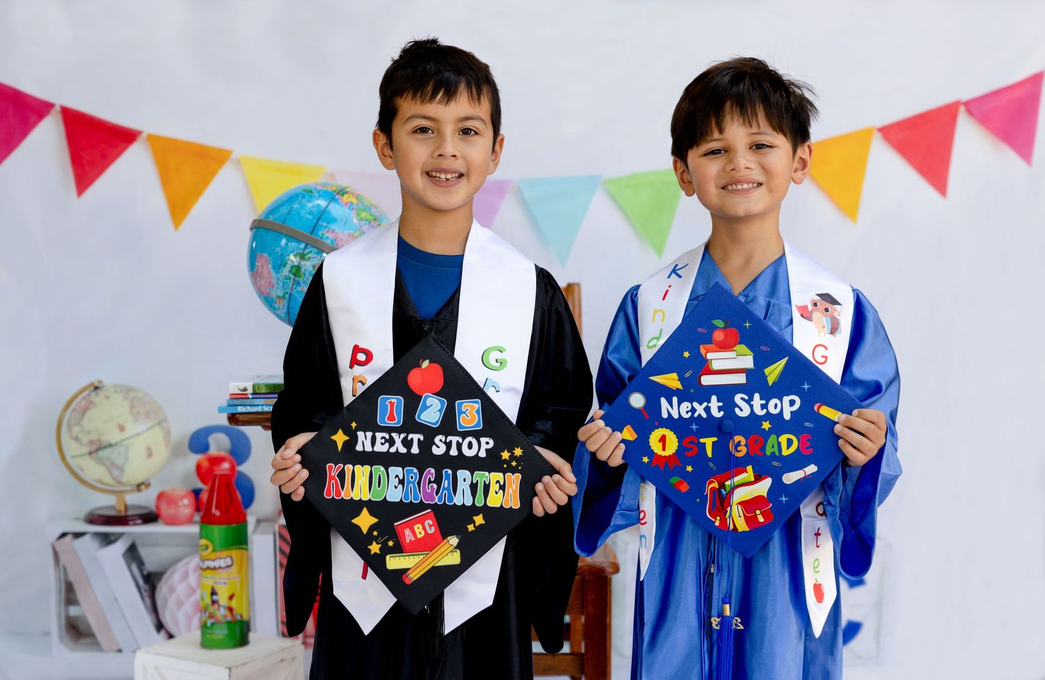 Festive graduation photo setup with colorful bunting and educational props.