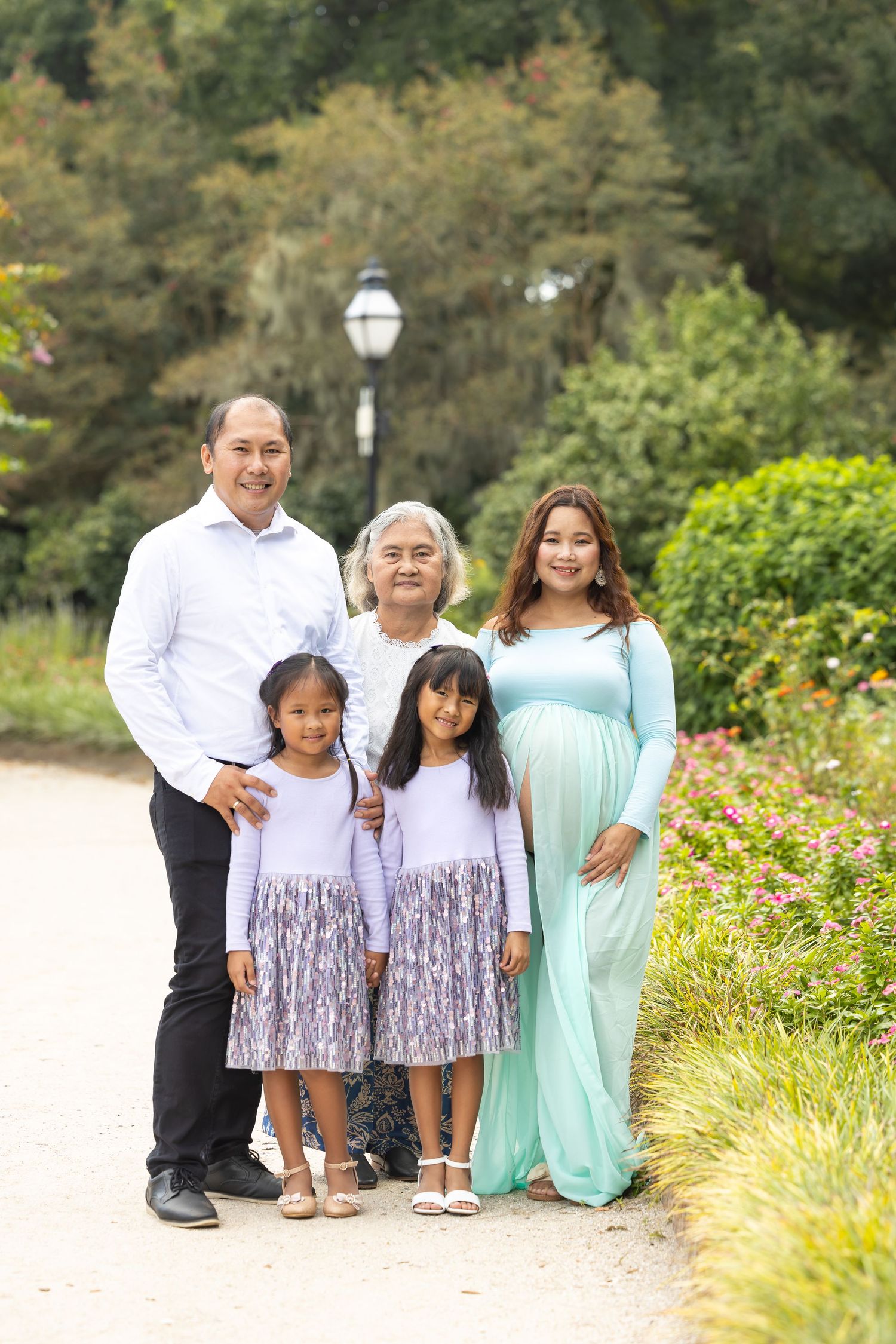 Family portrait session in garden setting with coordinated outfits.