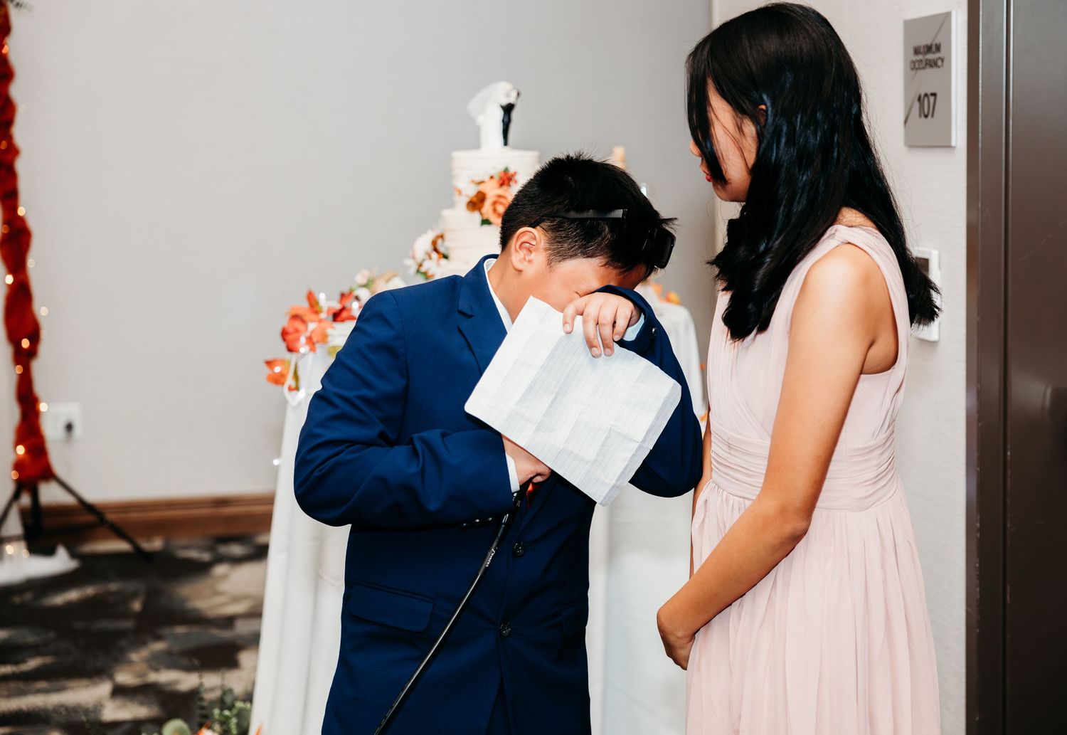 Wedding couple sharing romantic moments in a modern indoor setting.