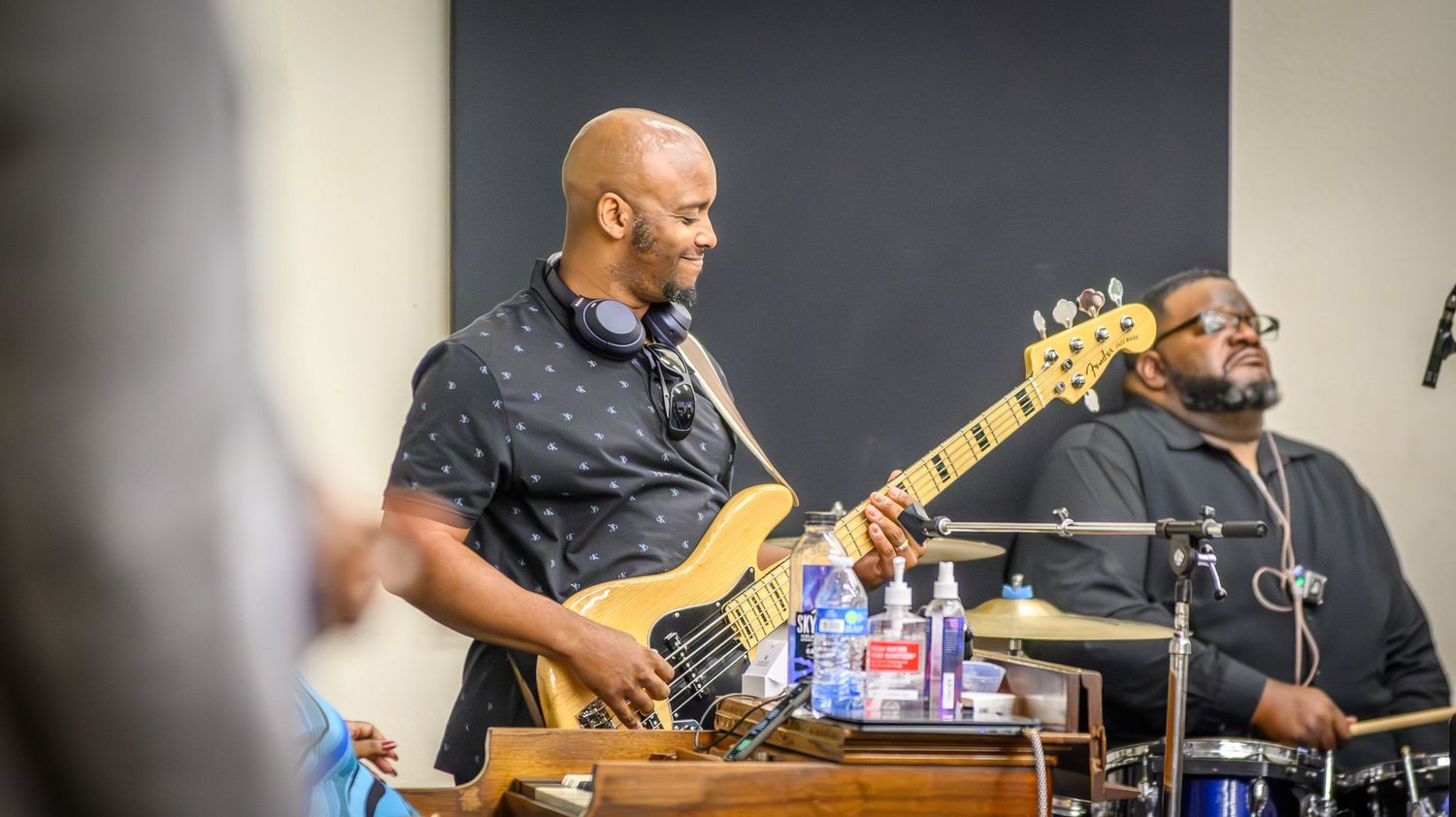 Musicians perform on stage with guitars and instruments during a live performance.