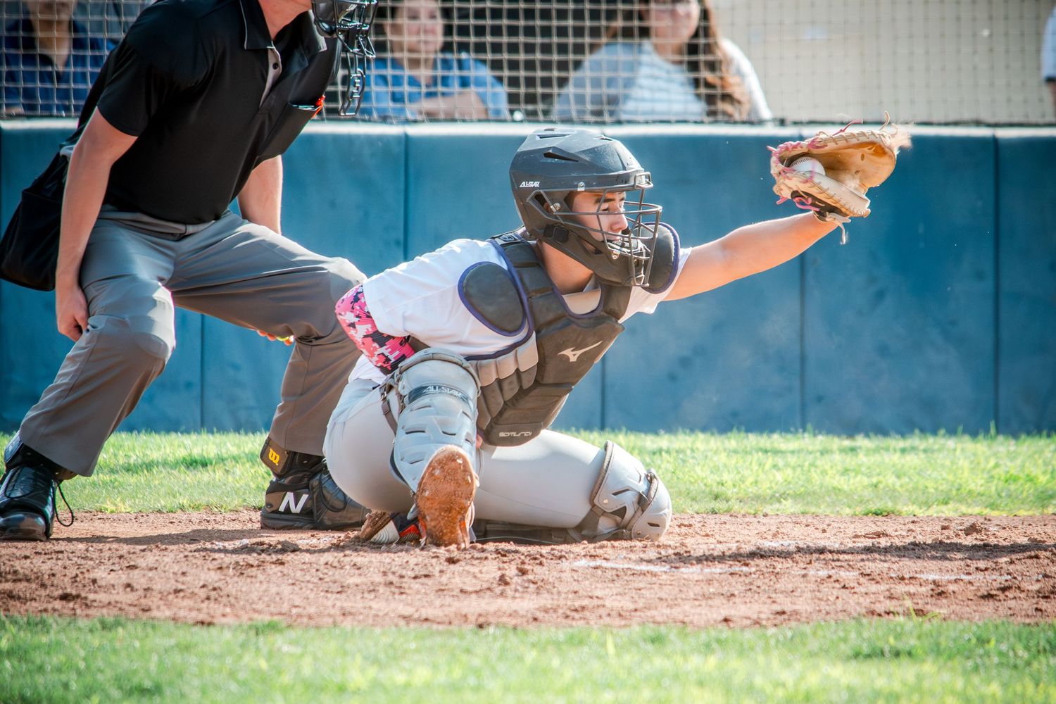 Baseball action sequence showing batter and catcher at home plate during game.
