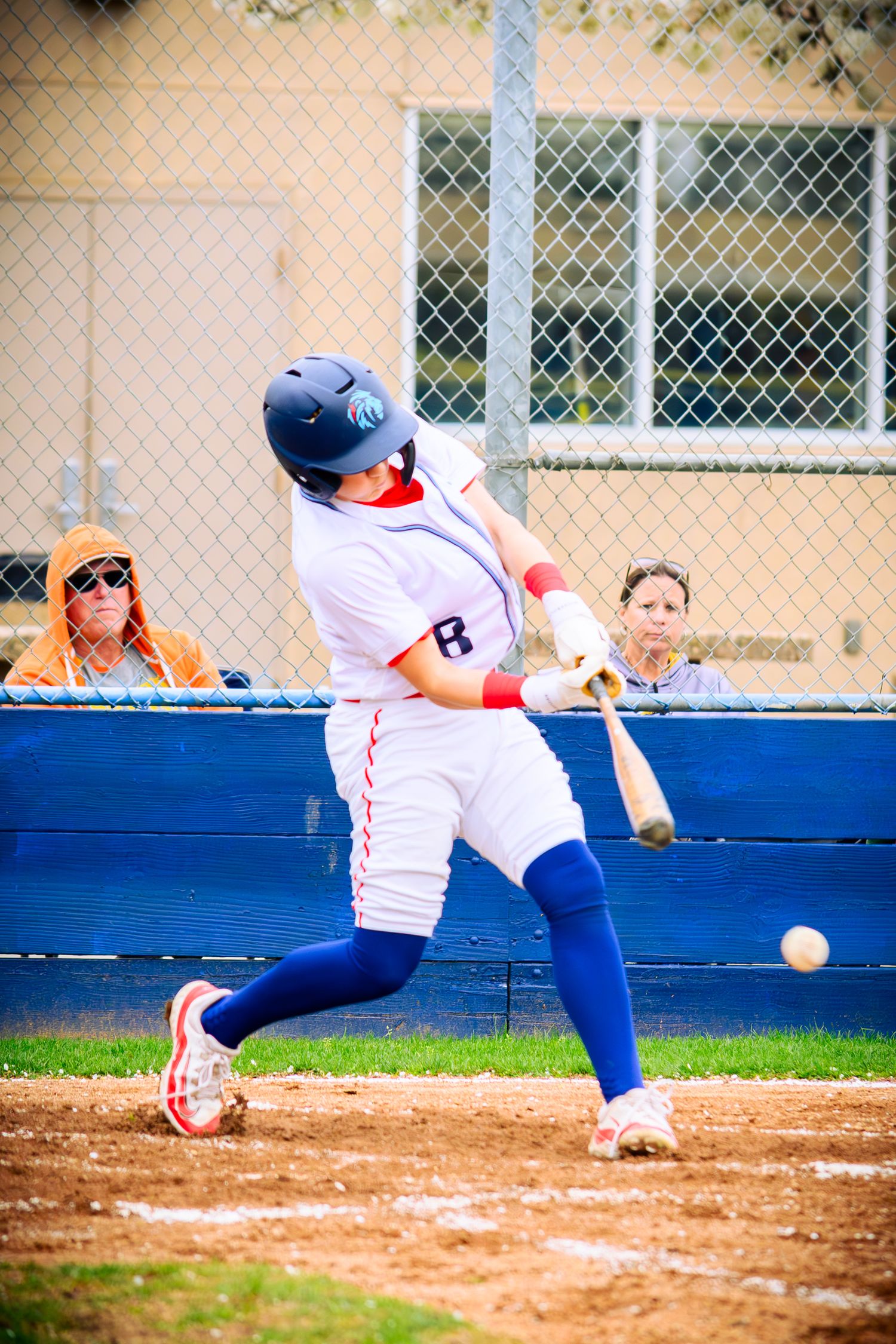 Baseball player slides into home plate during an intense play.
