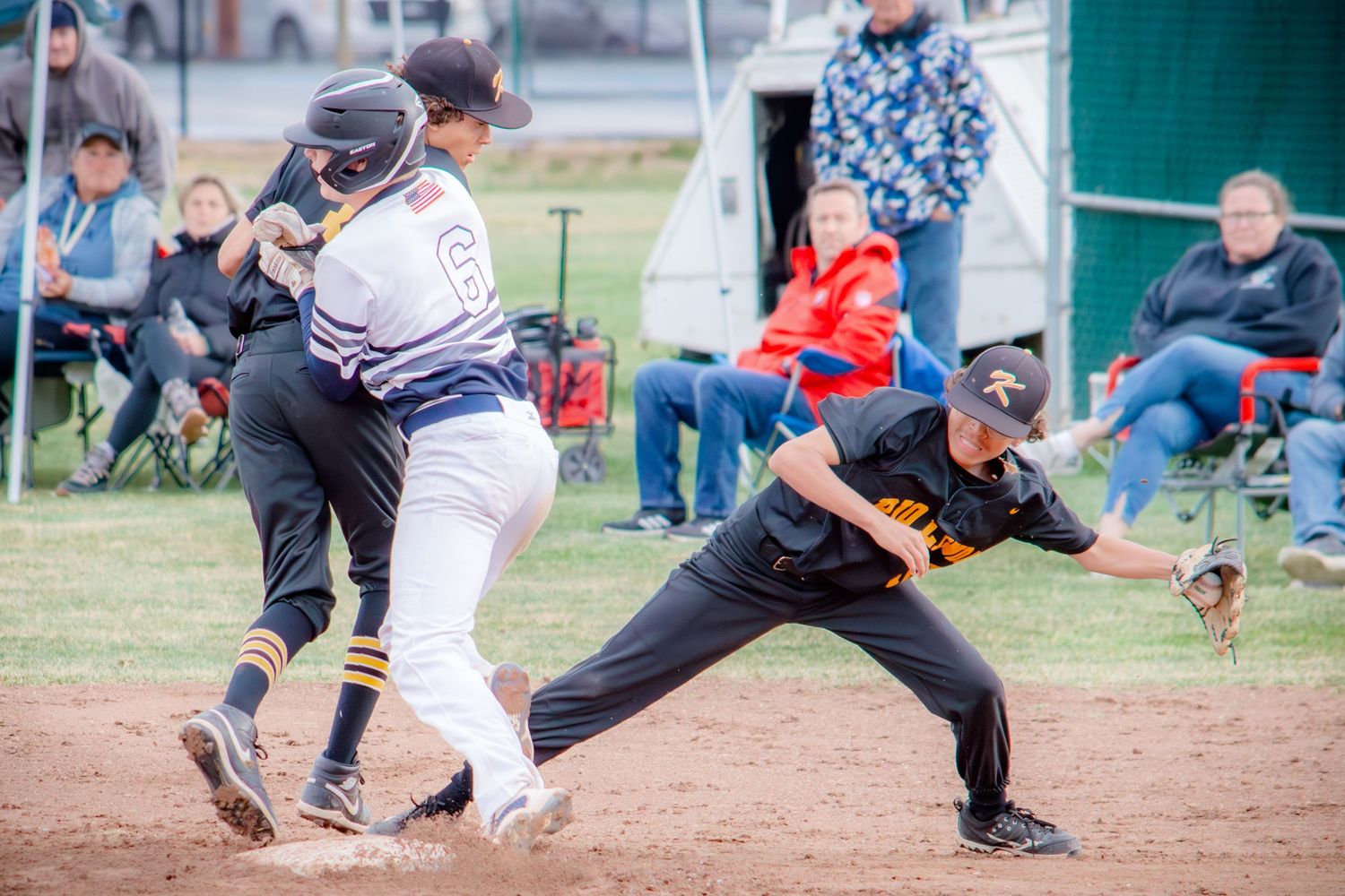 Dramatic sequence of baseball players colliding during a sliding play at the base.