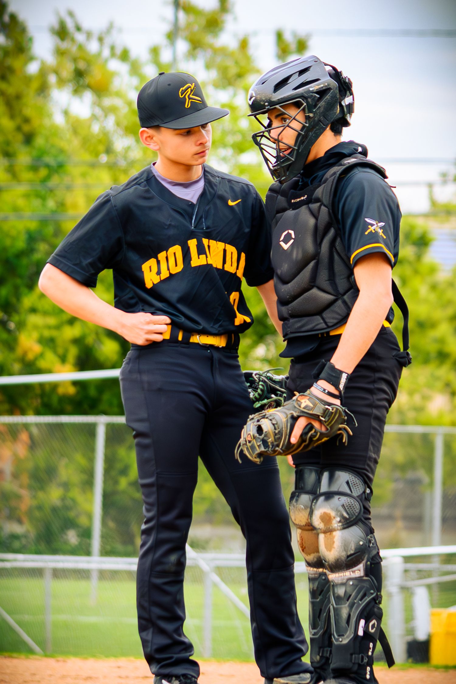 Close-up of catcher and pitcher conference on the baseball field during a game.