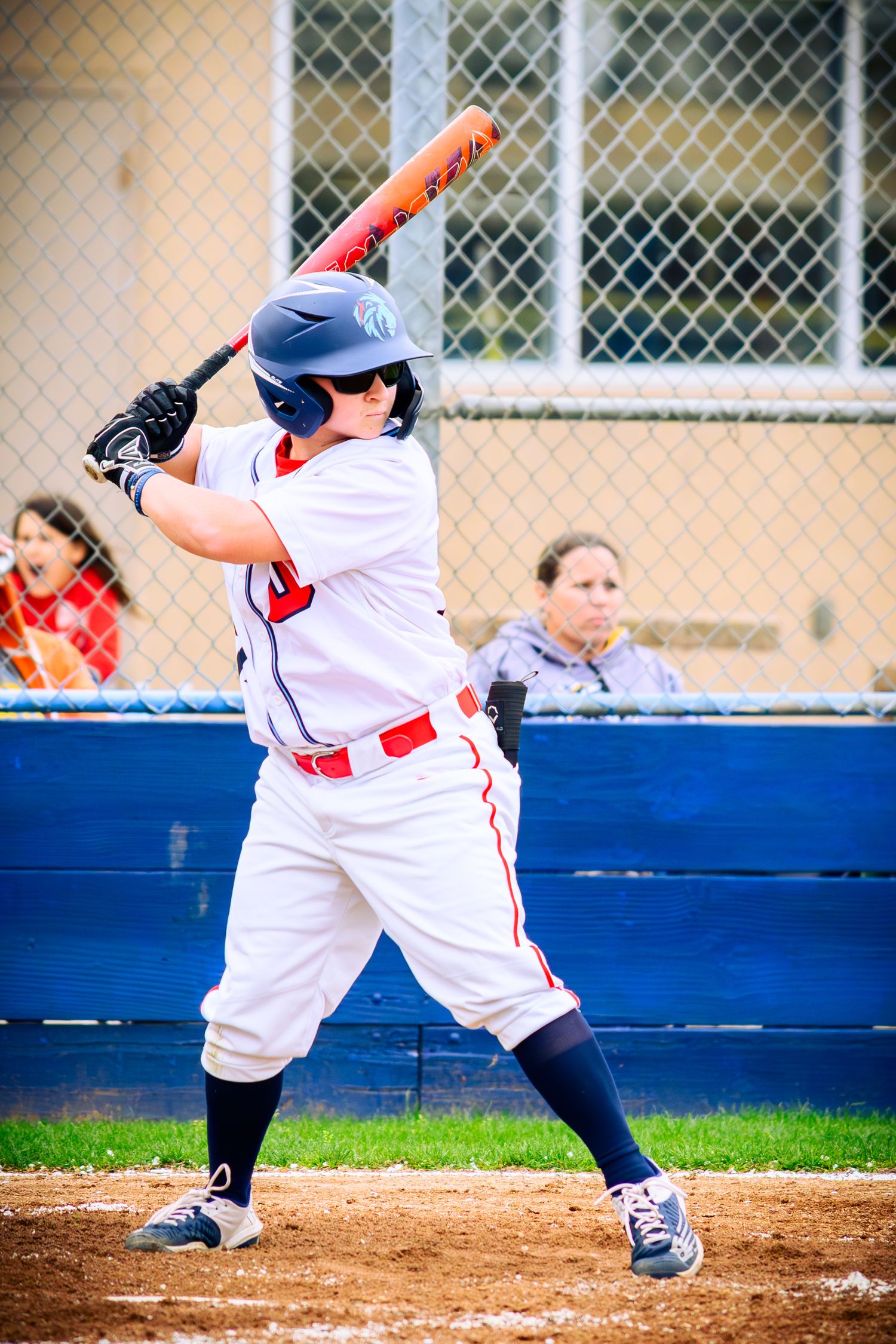 Baseball player in white uniform demonstrating batting stance sequence at home plate.