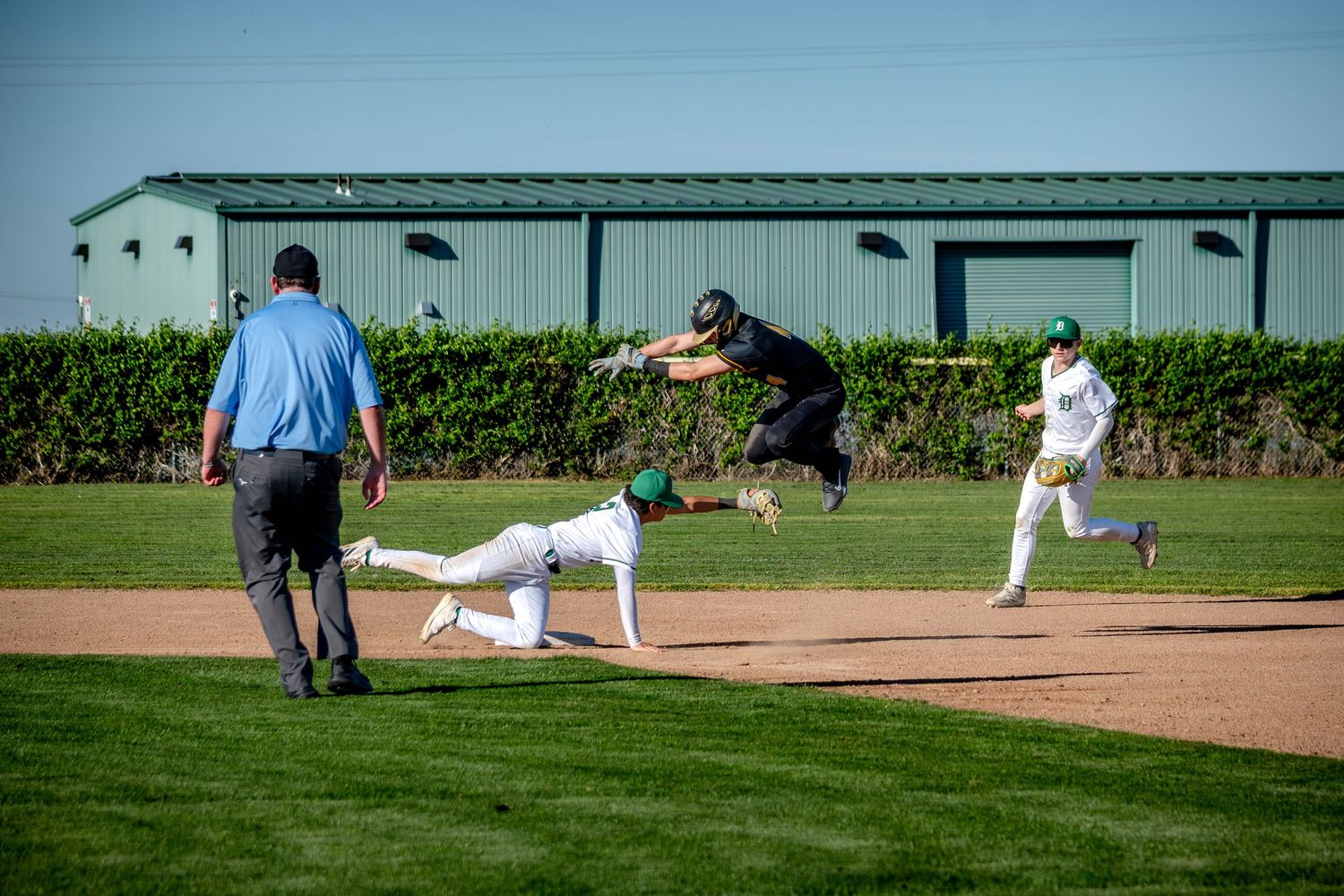 Baseball players dive and slide across multiple action shots during an intense game sequence on the field.