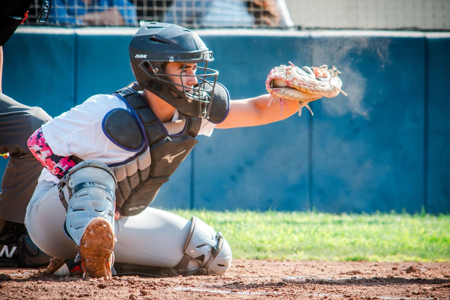Multiple image sequence shows a baseball player sliding into home plate during an intense play at the plate.
