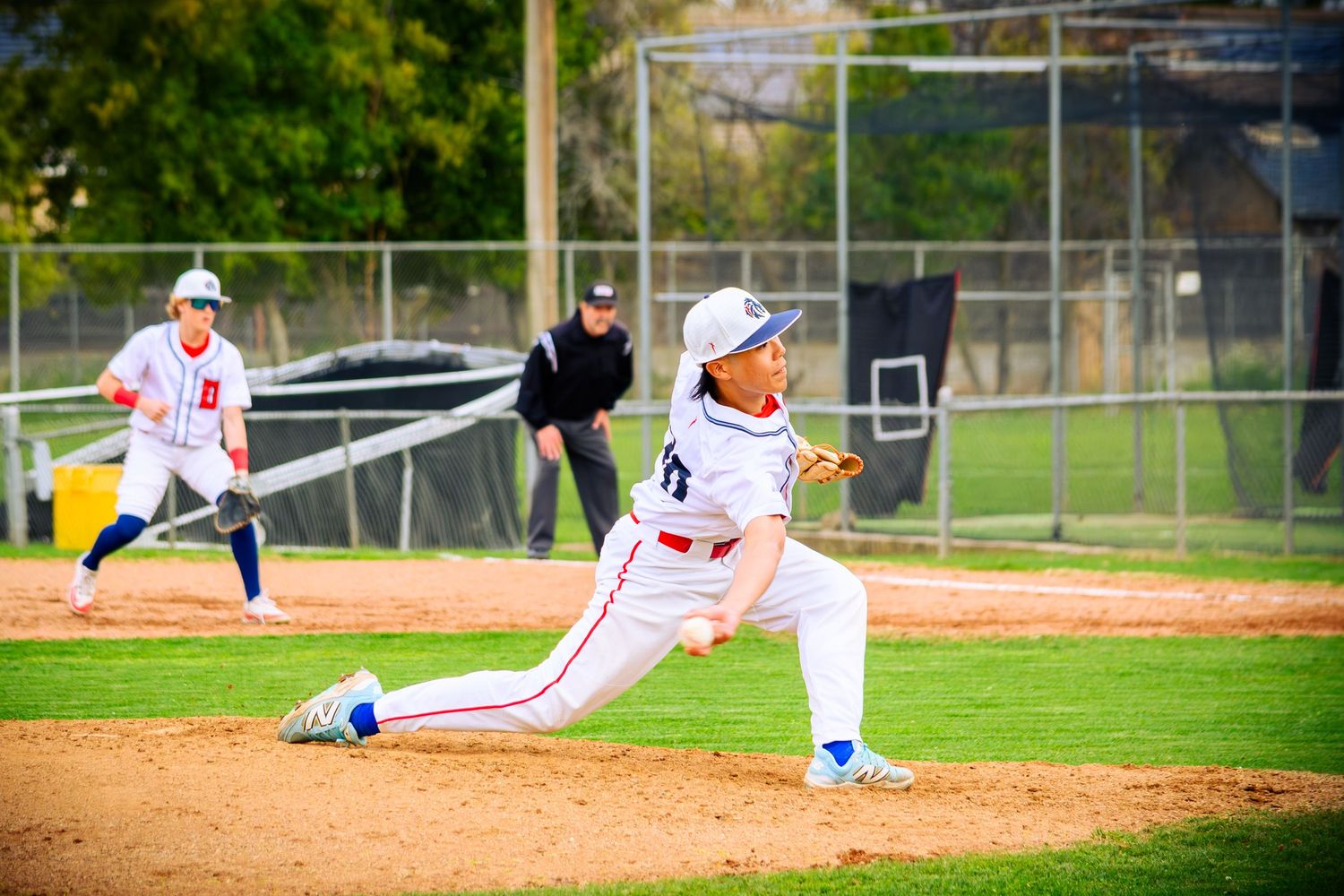 Baseball field with players spread out during a sunny game day.