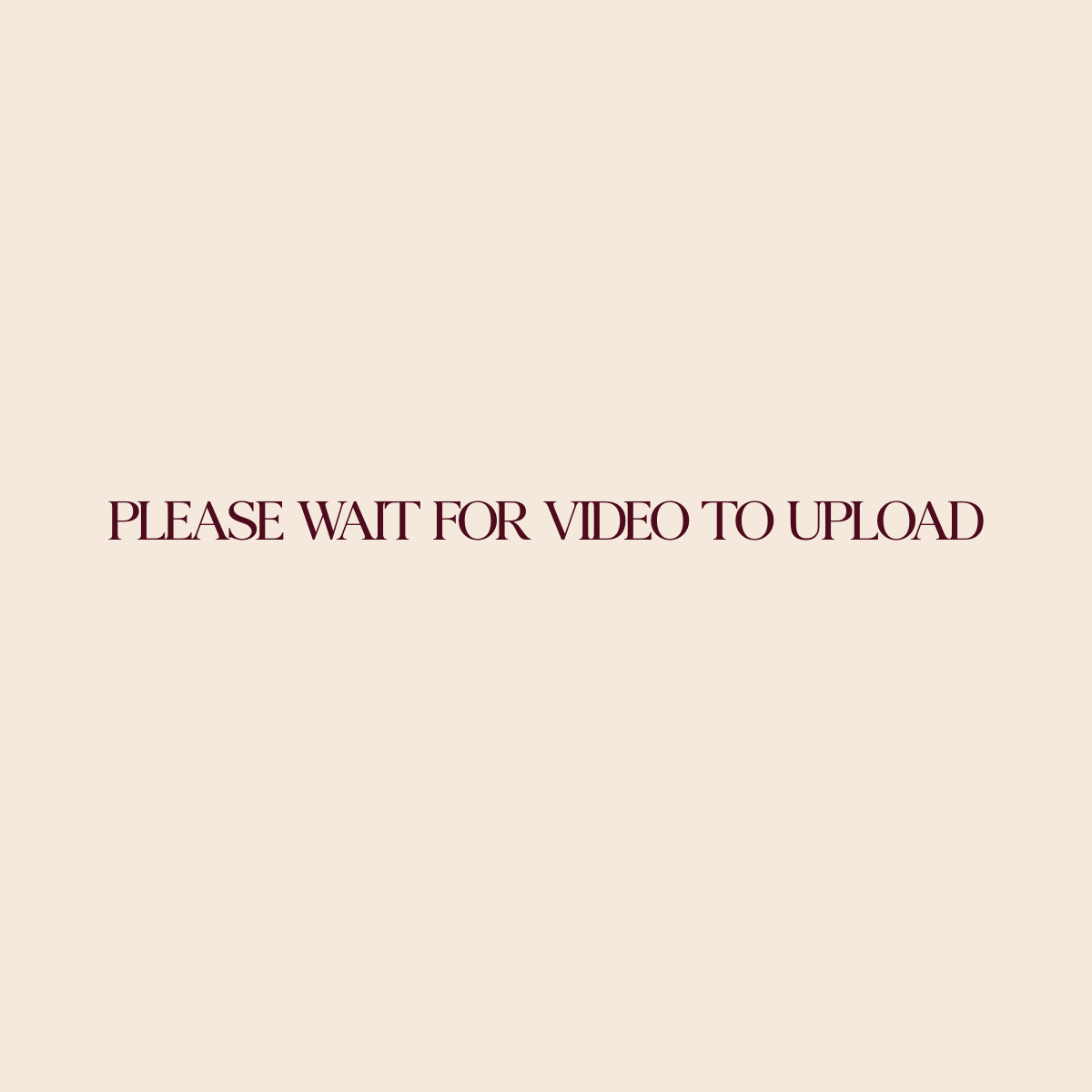 A simple pink placeholder image with text that reads 'Please wait for video to upload'.