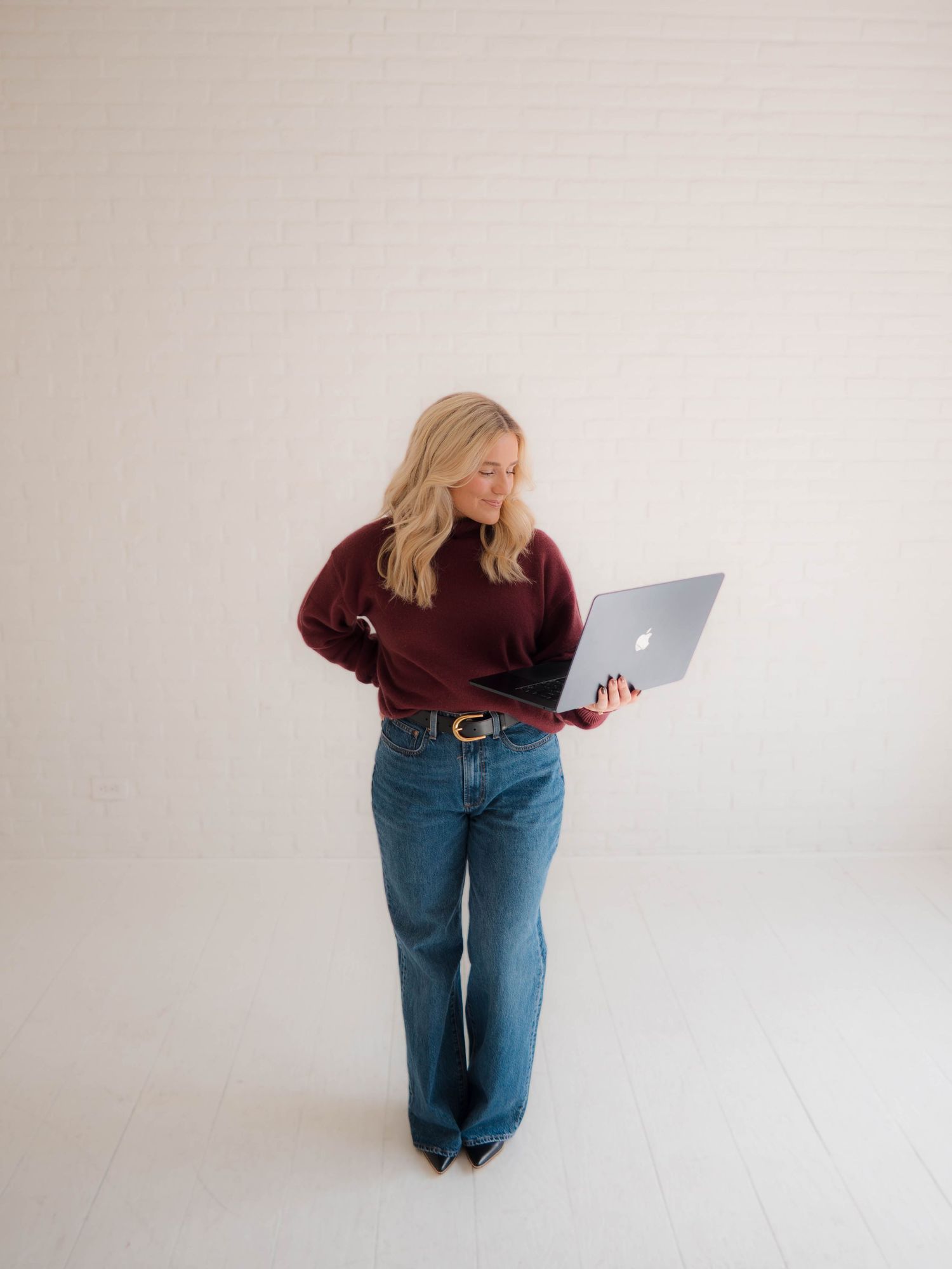 A figure in maroon top and blue jeans seen from different angles against a white background showing various poses.