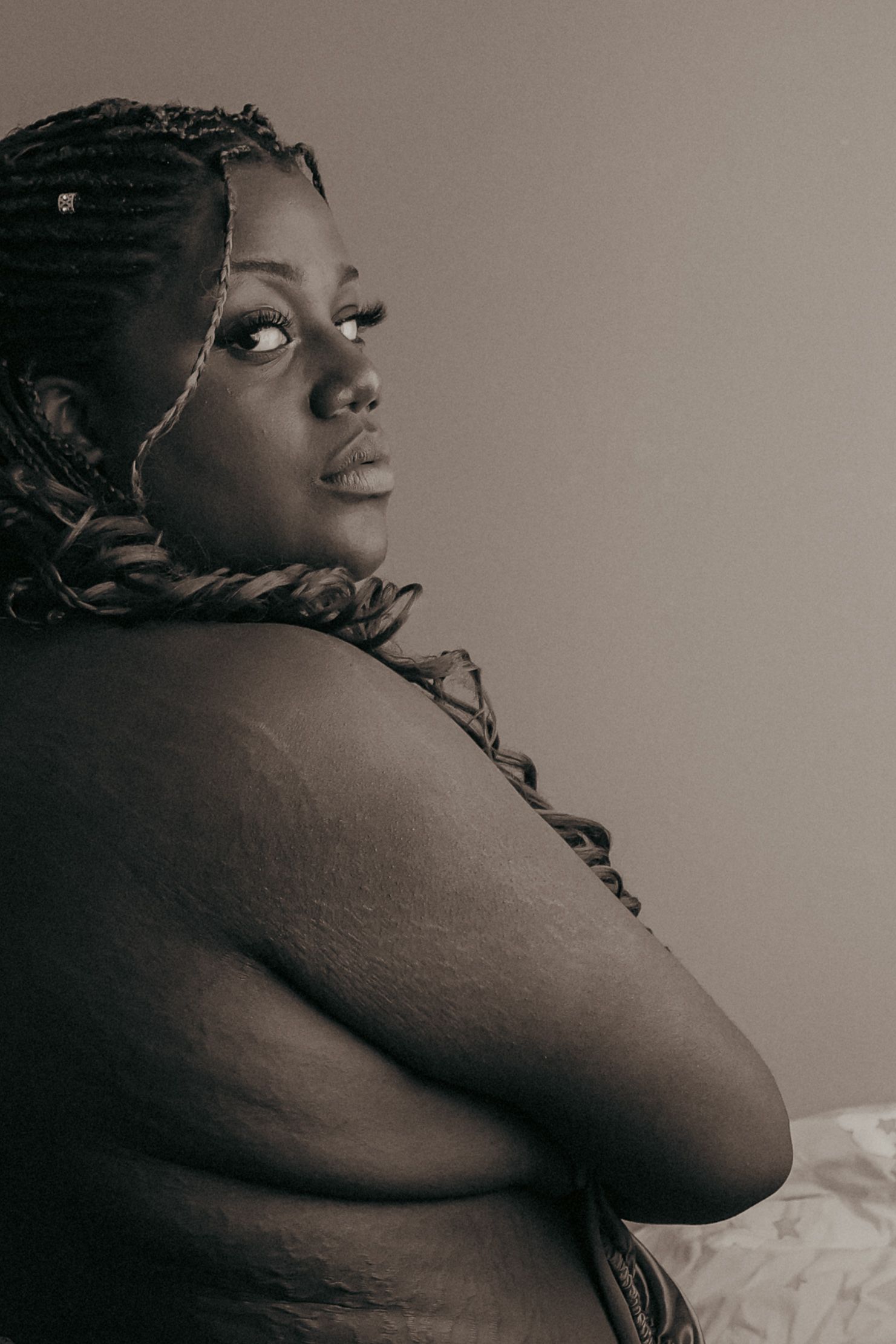 Beautiful, confident black woman, back turned to view, intense gaze, powerful, monochrome, suffolk empowerment photography